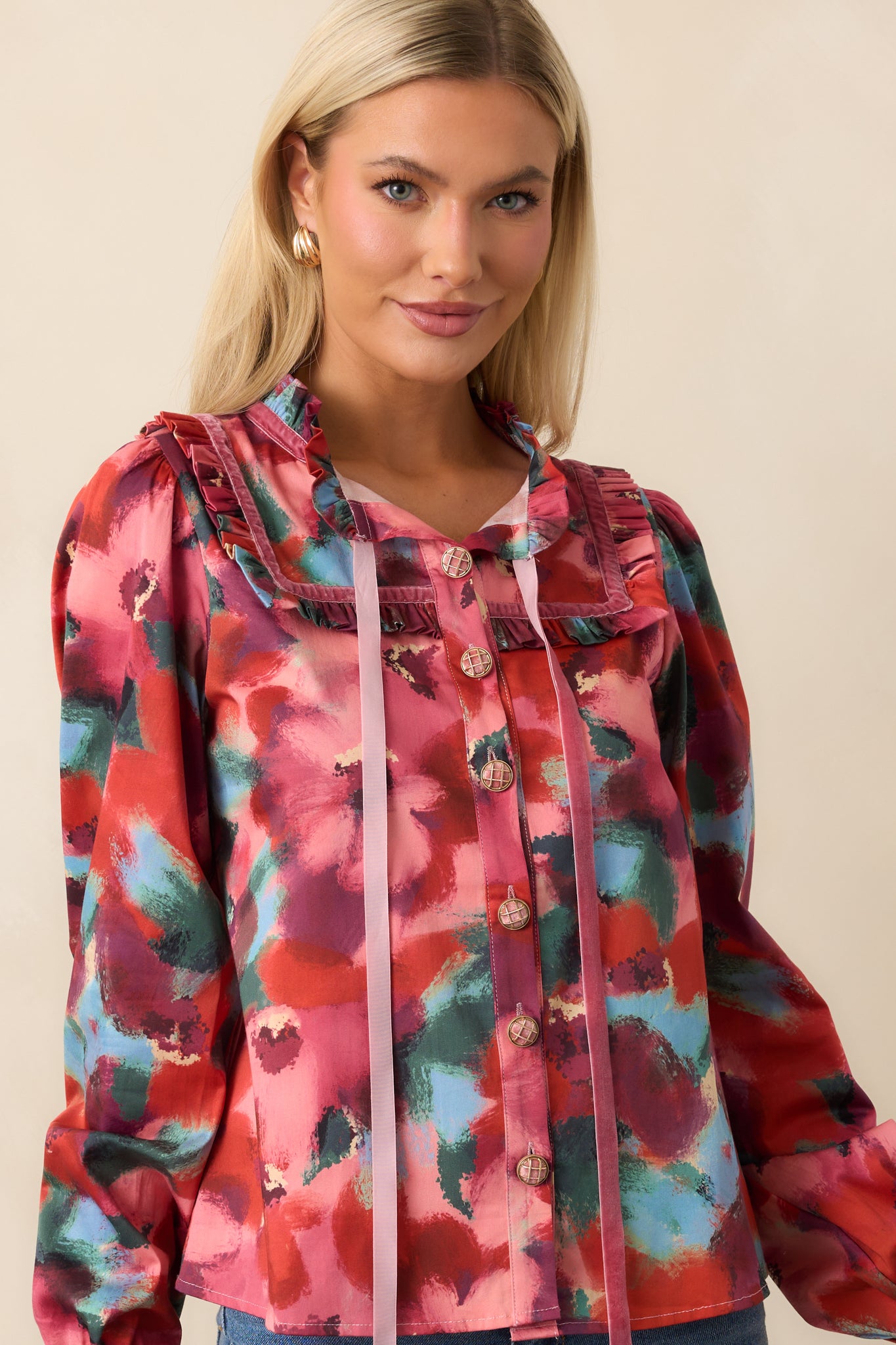 Close crop highlighting the top’s sailor-inspired ruffle collar, V-neck with ribbon ties, and floral print across the chest and shoulders.