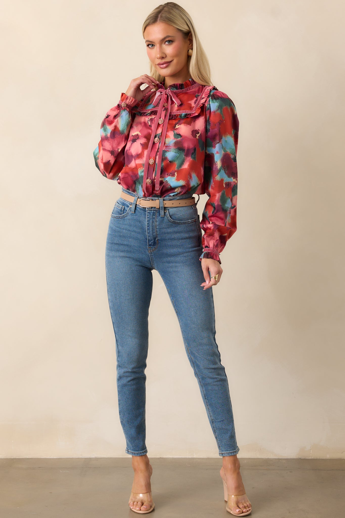 Front view highlighting a pink abstract floral top with long ribbon ties, functional button front, and puff sleeves with ruffled cuffs.