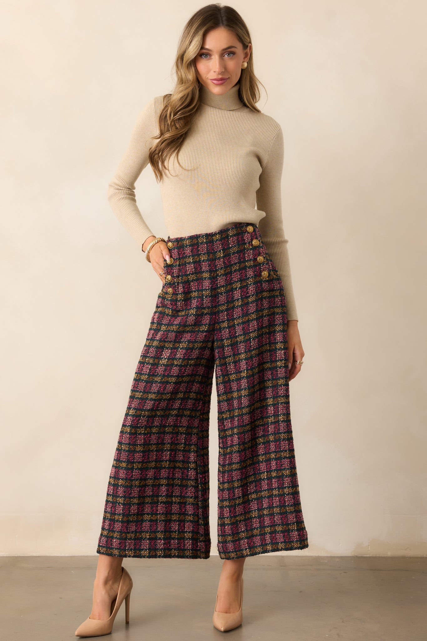 Pink and green plaid tweed high-rise pants styled to showcase their wide-leg cropped silhouette and tailored fit.