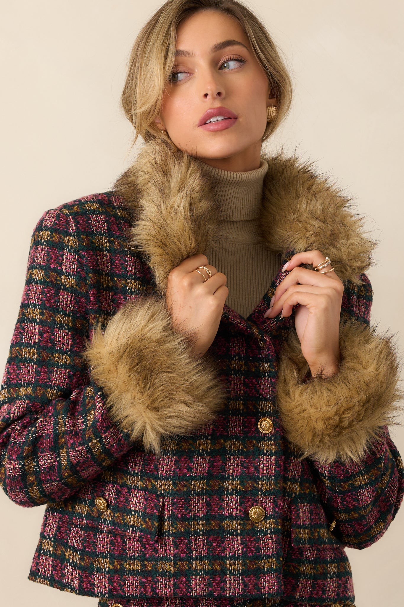 Detailed view of the faux fur cuffs and buttoned sleeve seam.