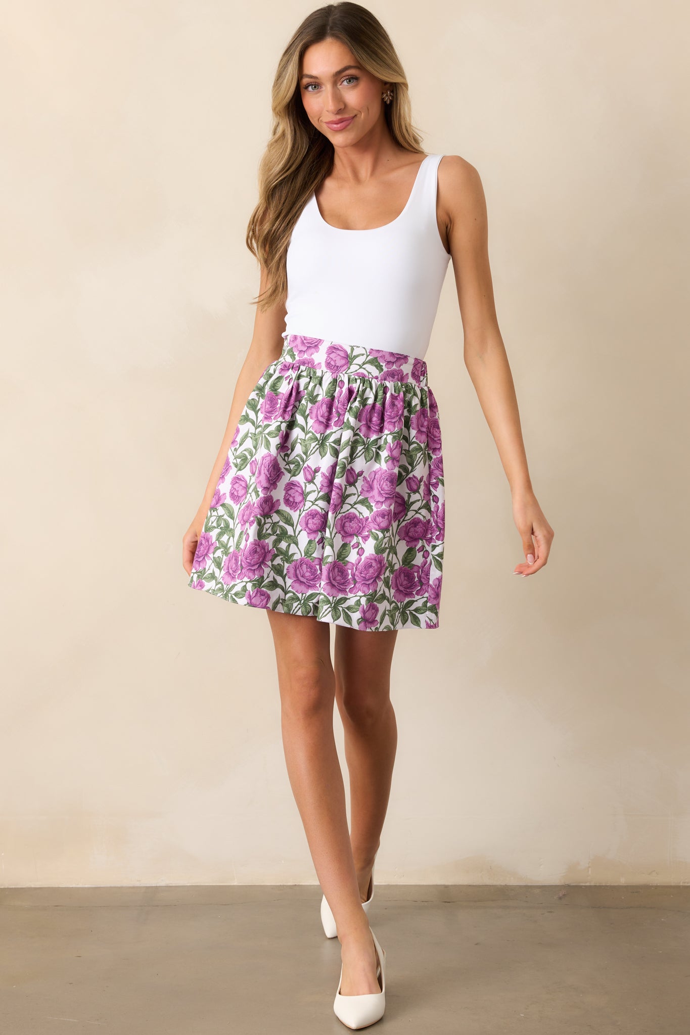 A reversible mini skirt featuring a vibrant violet bloom print on one side, a soft lilac hue on the other, and a flattering high-waisted fit.
