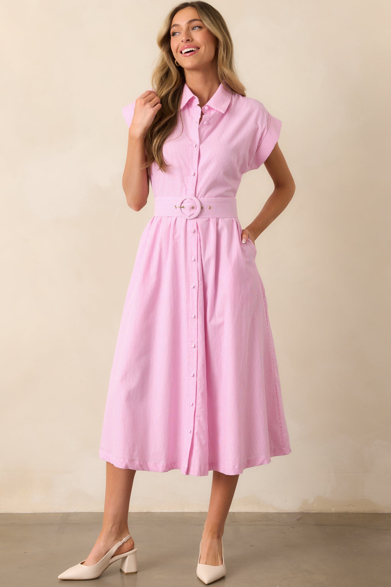 The pink dress displayed in a full-length shot, highlighting the functional matching fabric button front.