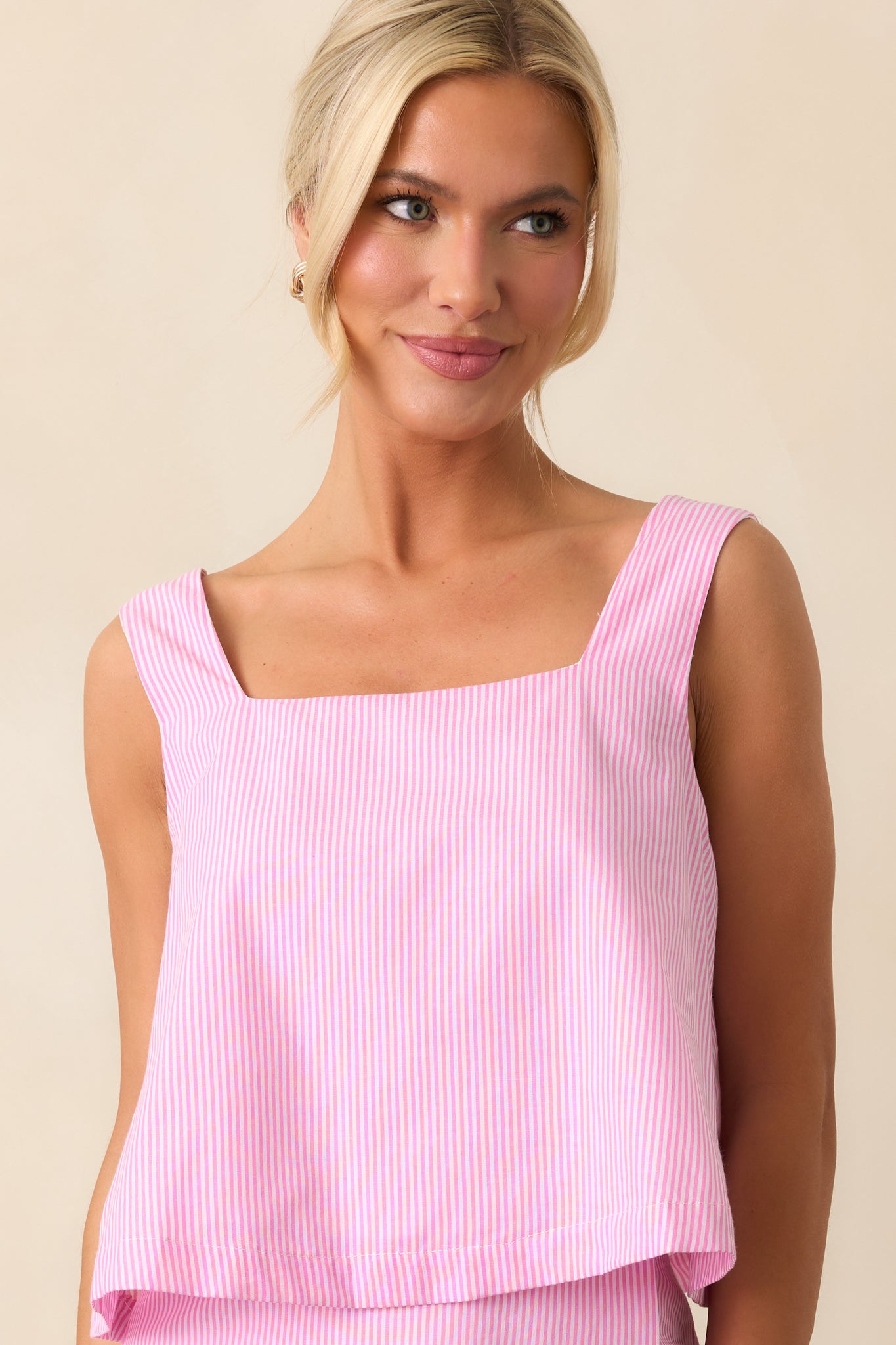 A detailed view of the stripe print and square neckline, emphasizing the texture and stylish design of this peony pink cropped top.