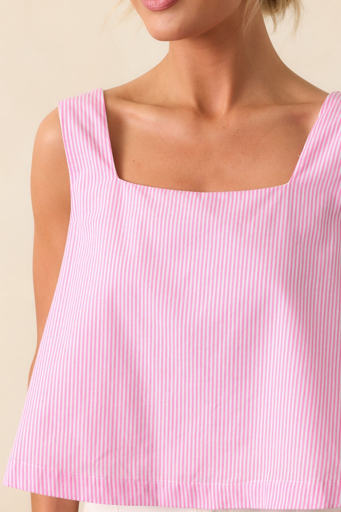 A closer look at the square neckline and sleeveless design, with the bold stripe print adding a modern touch to this peony pink cropped top.