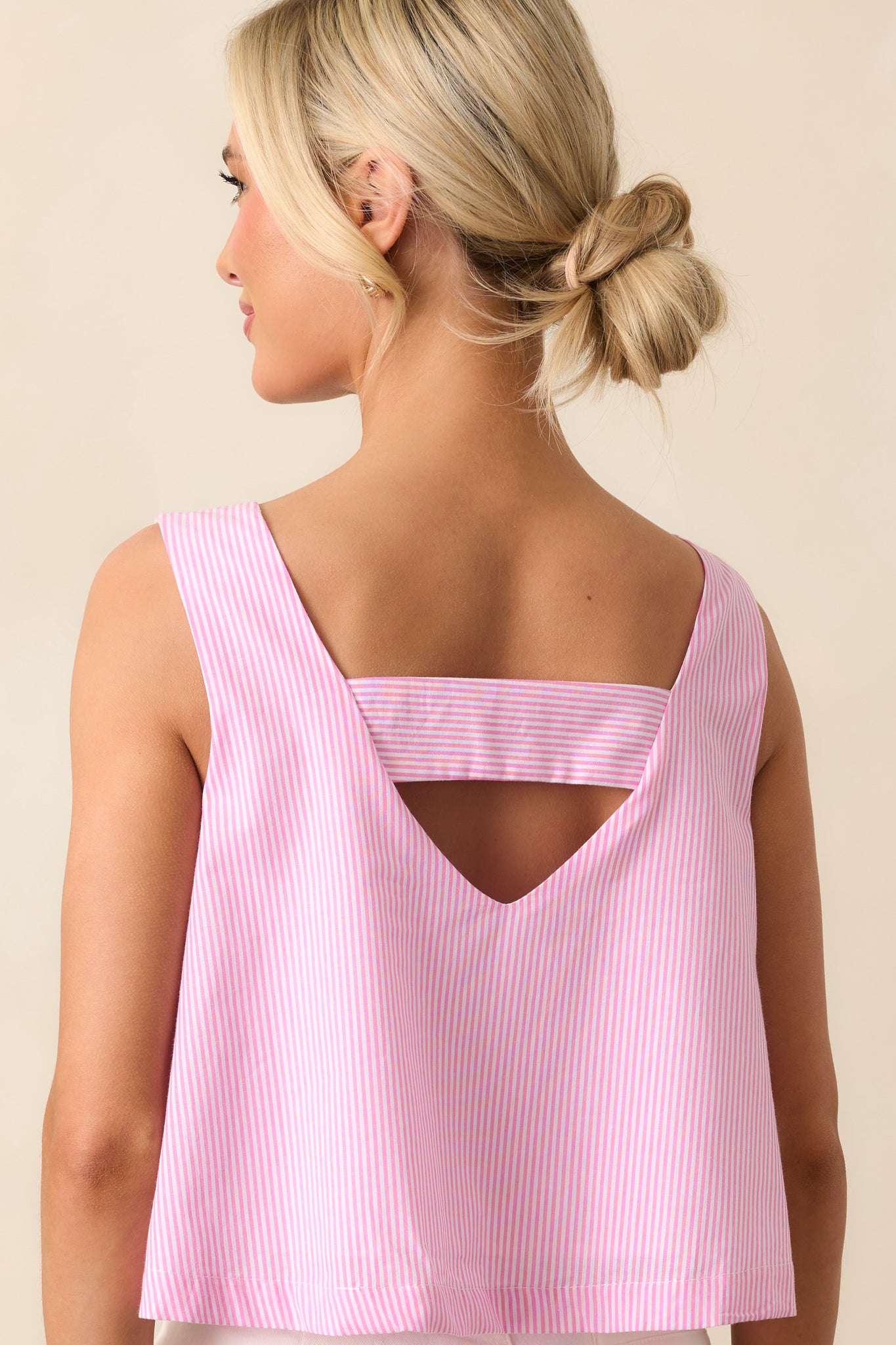 The back of this peony pink top offers a simple, clean design, with the sleeveless tank style and cropped length completing the fresh look.