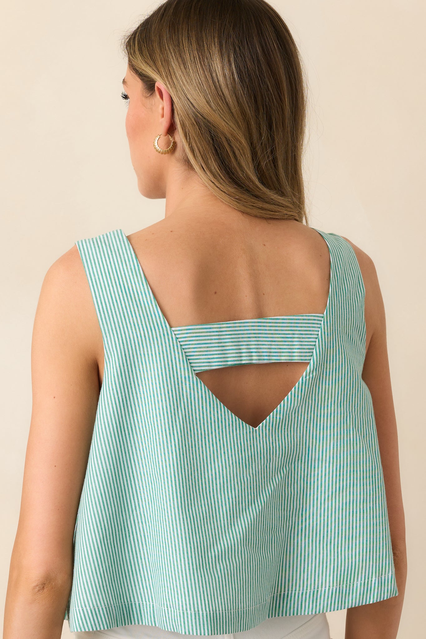 The back view of the green cropped tank top, showcasing its seamless finish and sleeveless cut.