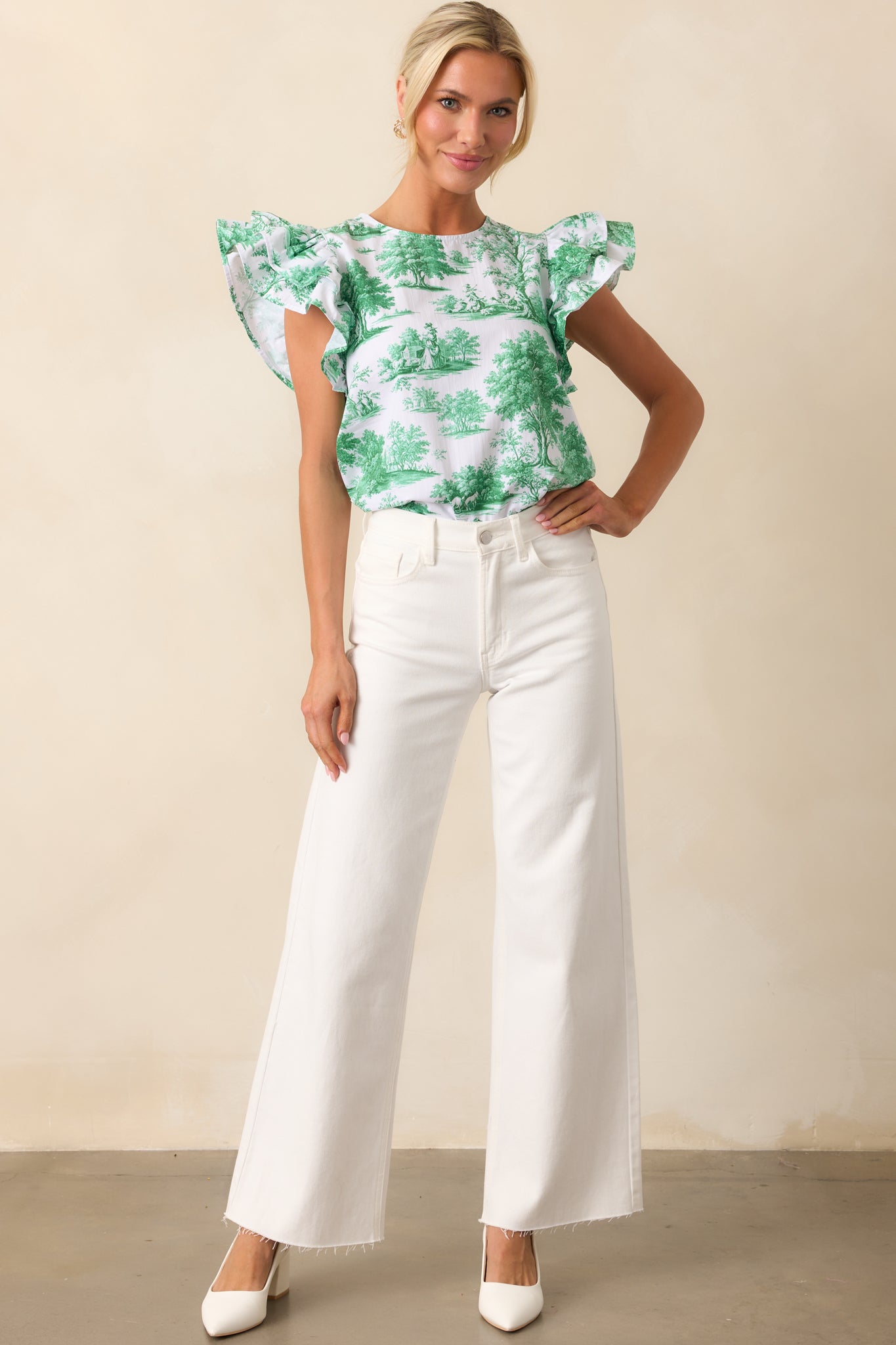 A front-facing view of the eden green toile print top, showcasing its round neckline and flutter sleeves.