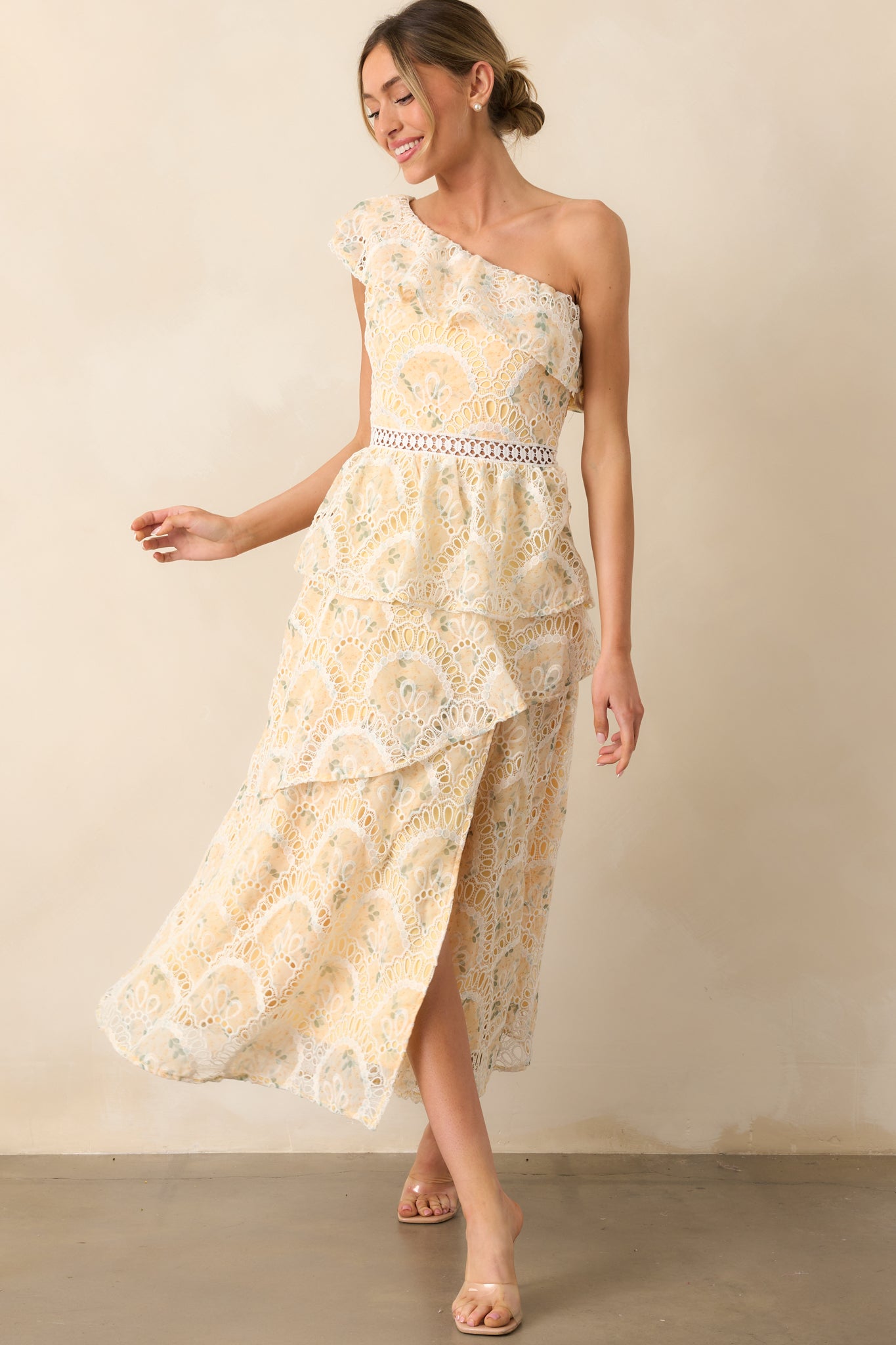 A vibrant yellow midi dress with floral embroidery throughout, a ruffled skirt, and a stylish side slit.