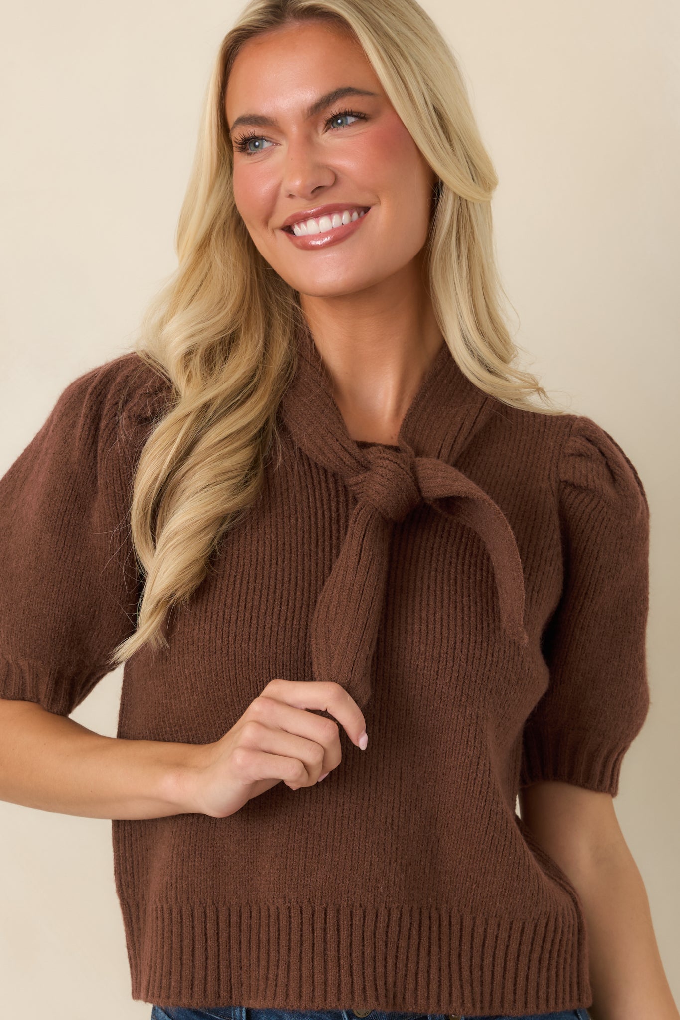 Detailed look at the puff sleeve design featuring ribbed cuffs and soft knit construction.