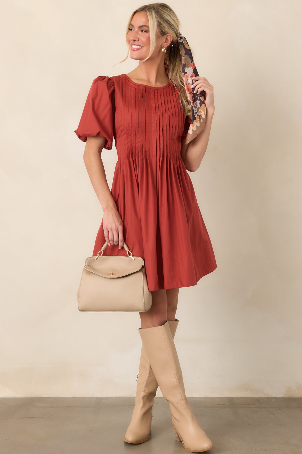 Voluminous short puff sleeves frame the pintucked bodice, which releases into a full skirt with soft gathers.