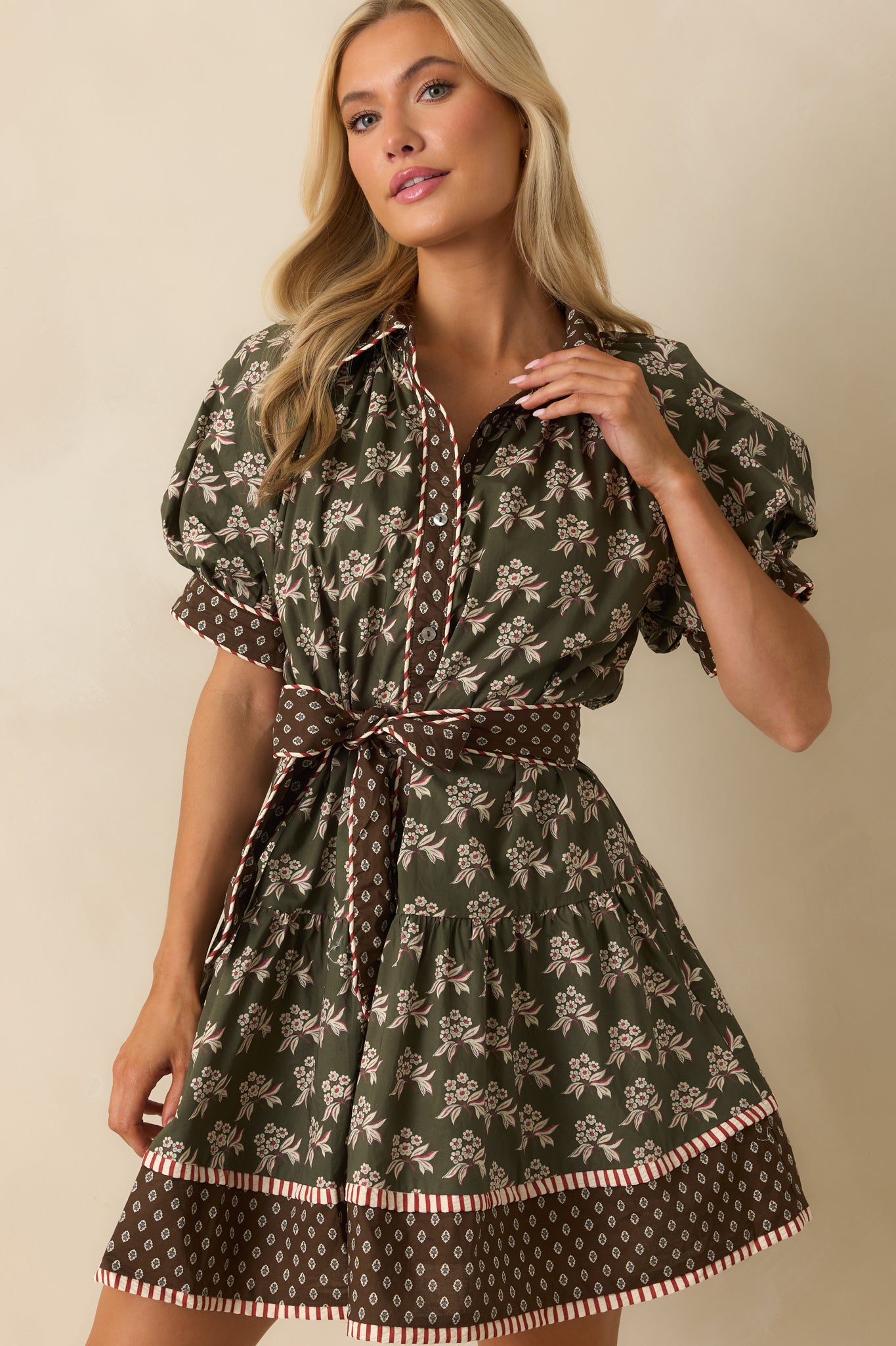Short puff sleeve with contrasting cuff detail and olive floral pattern.