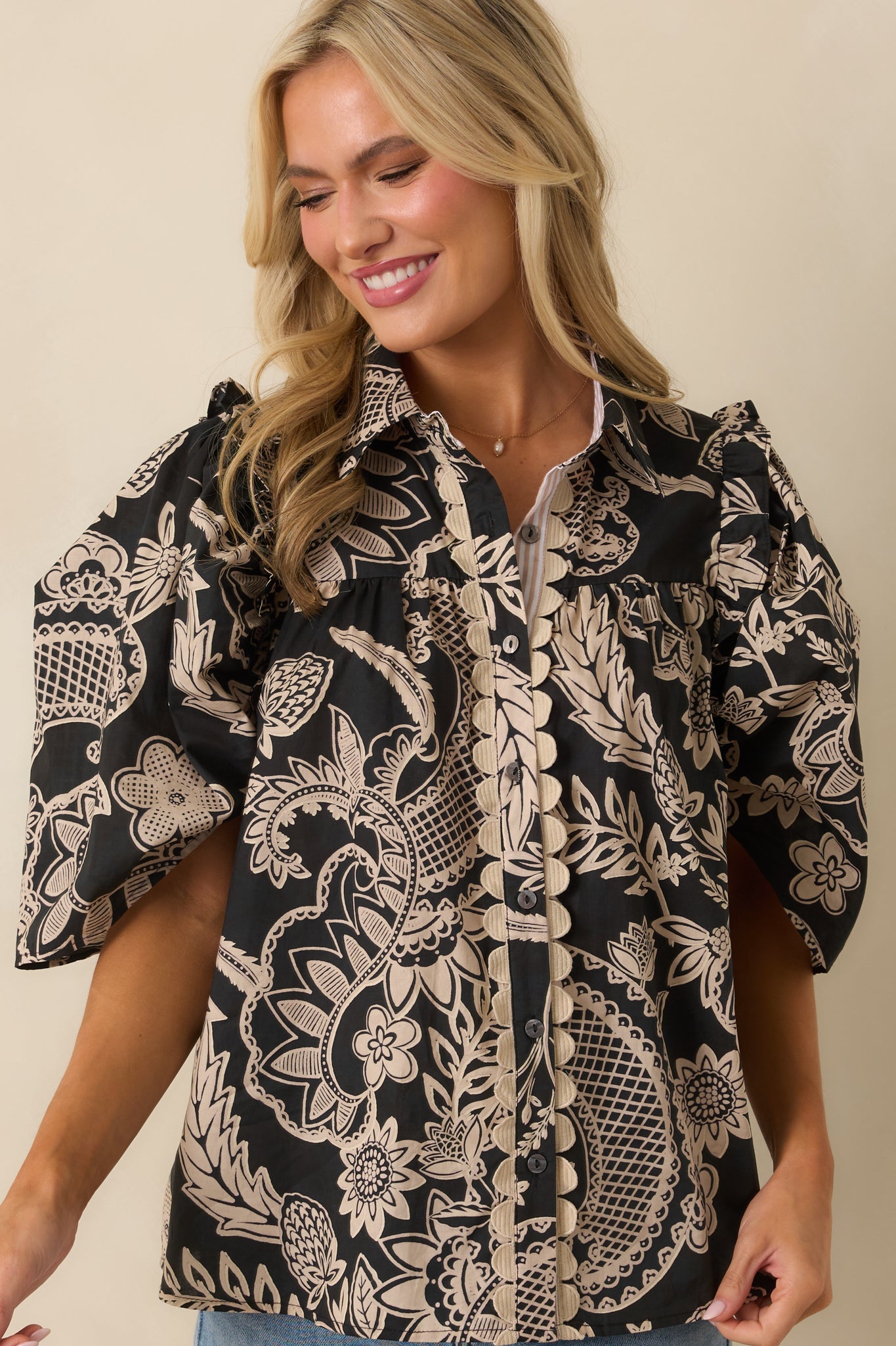 Detail of the puff sleeve texture and floral pattern along the shoulder and upper arm.