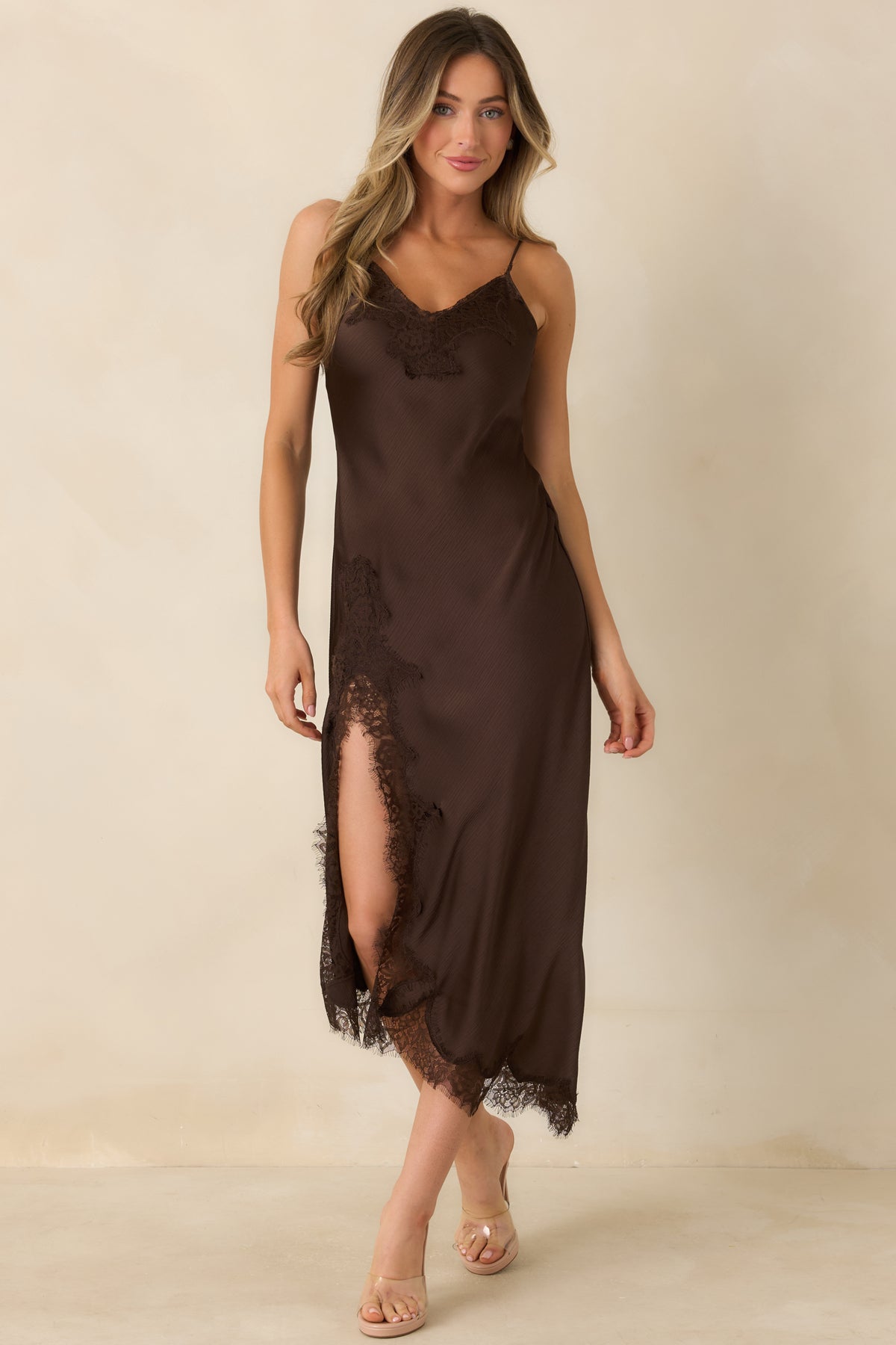 Pull-on bias-cut dress with a textured satin surface and flowing lace-accented hem.