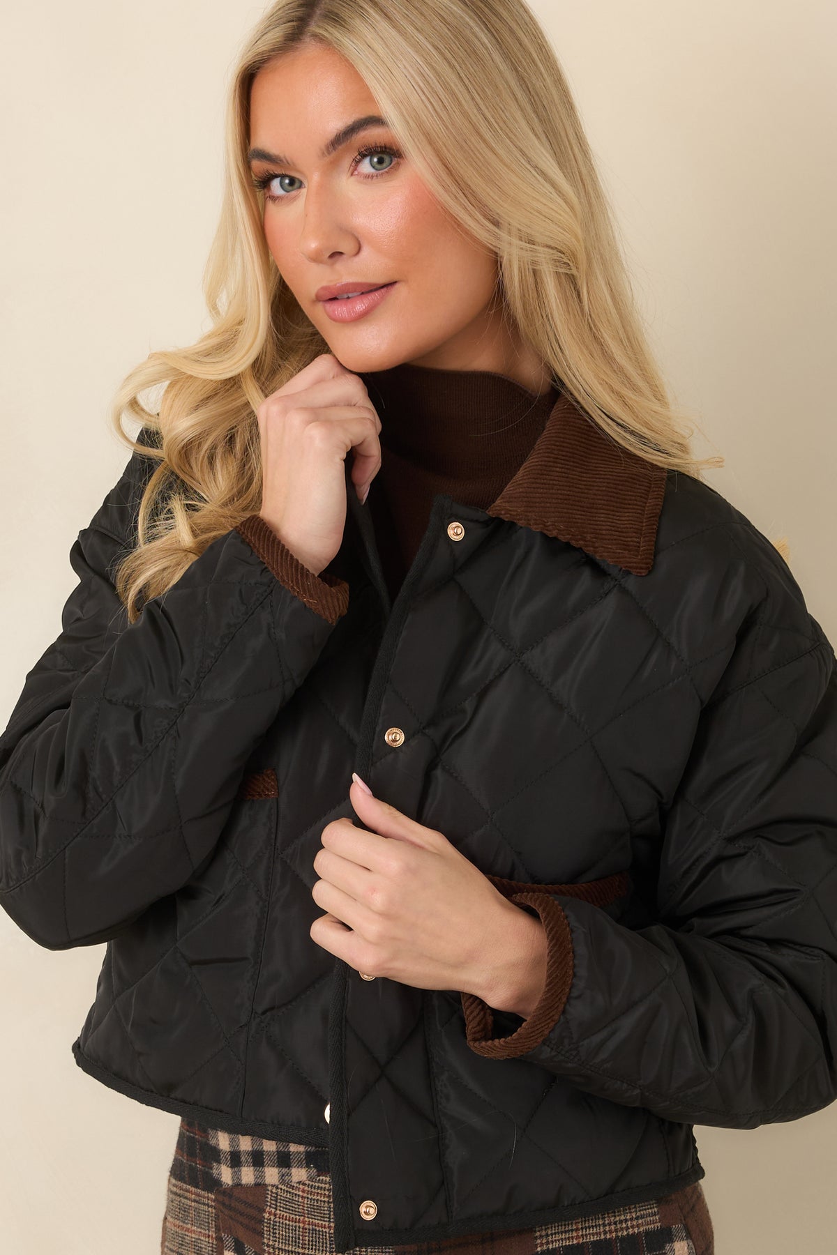 Diamond stitching creates a classic quilted pattern across the front panels of the jacket.
