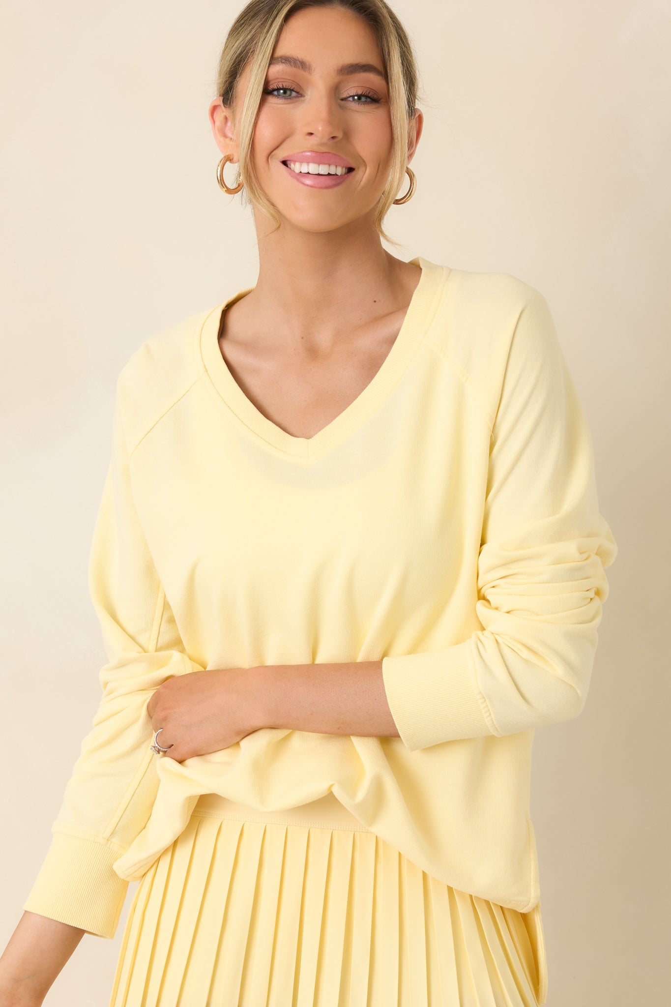 Raglan sleeve seams blending smoothly into relaxed yellow silhouette.