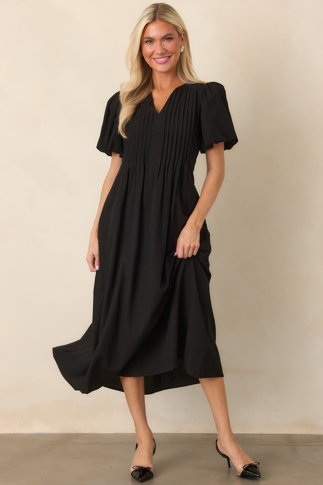 Rayon-nylon dress with a relaxed midi silhouette, softly gathered sleeves, detailed front pintucks, and a fluid skirt.