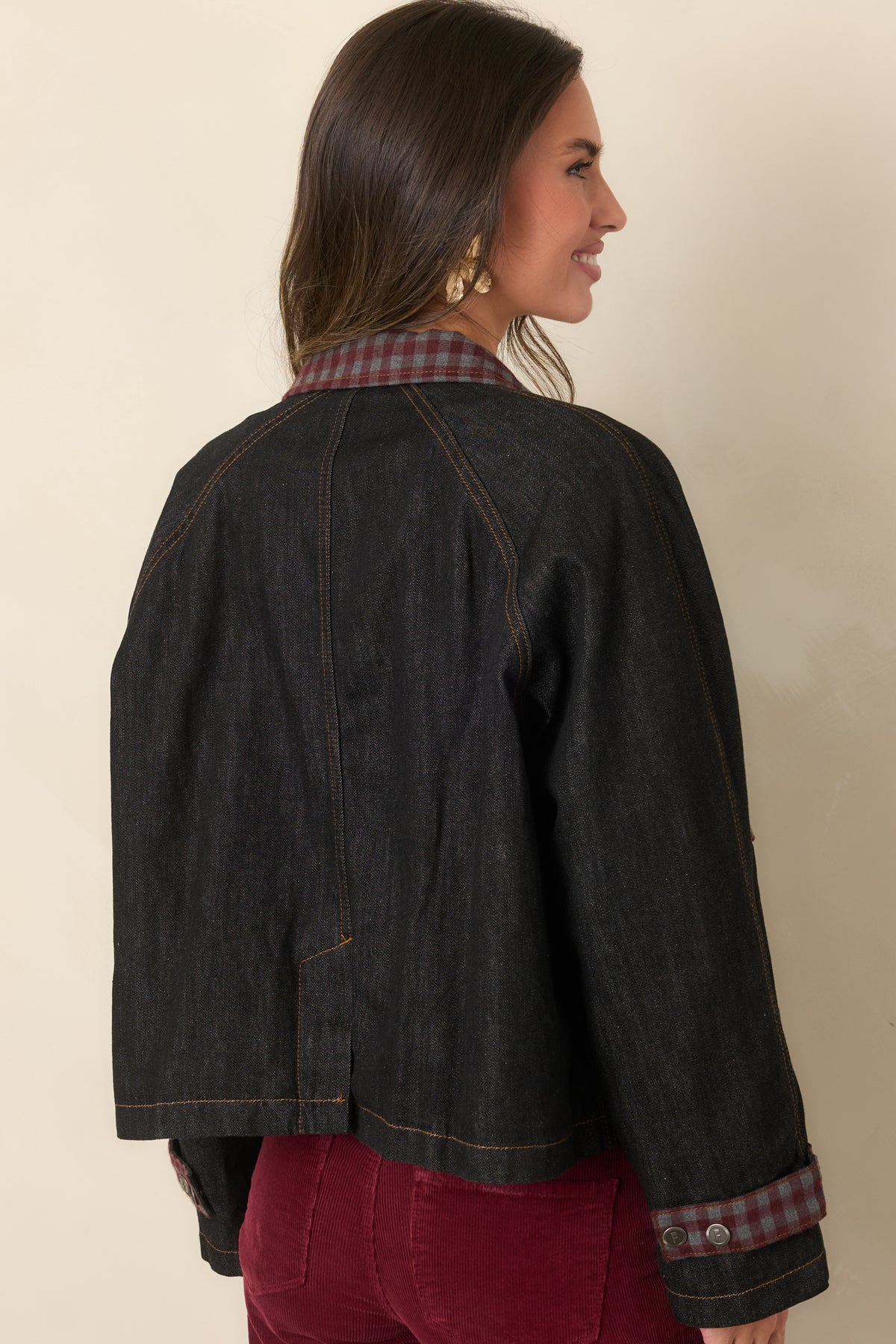 Rear of the deep blue denim jacket showcasing its relaxed boxy silhouette and raglan sleeves.