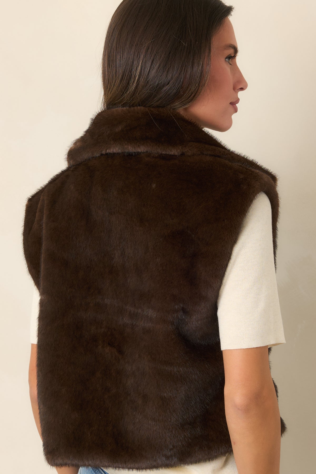 Rear of the chocolate brown faux fur vest showing its relaxed silhouette and plush texture.