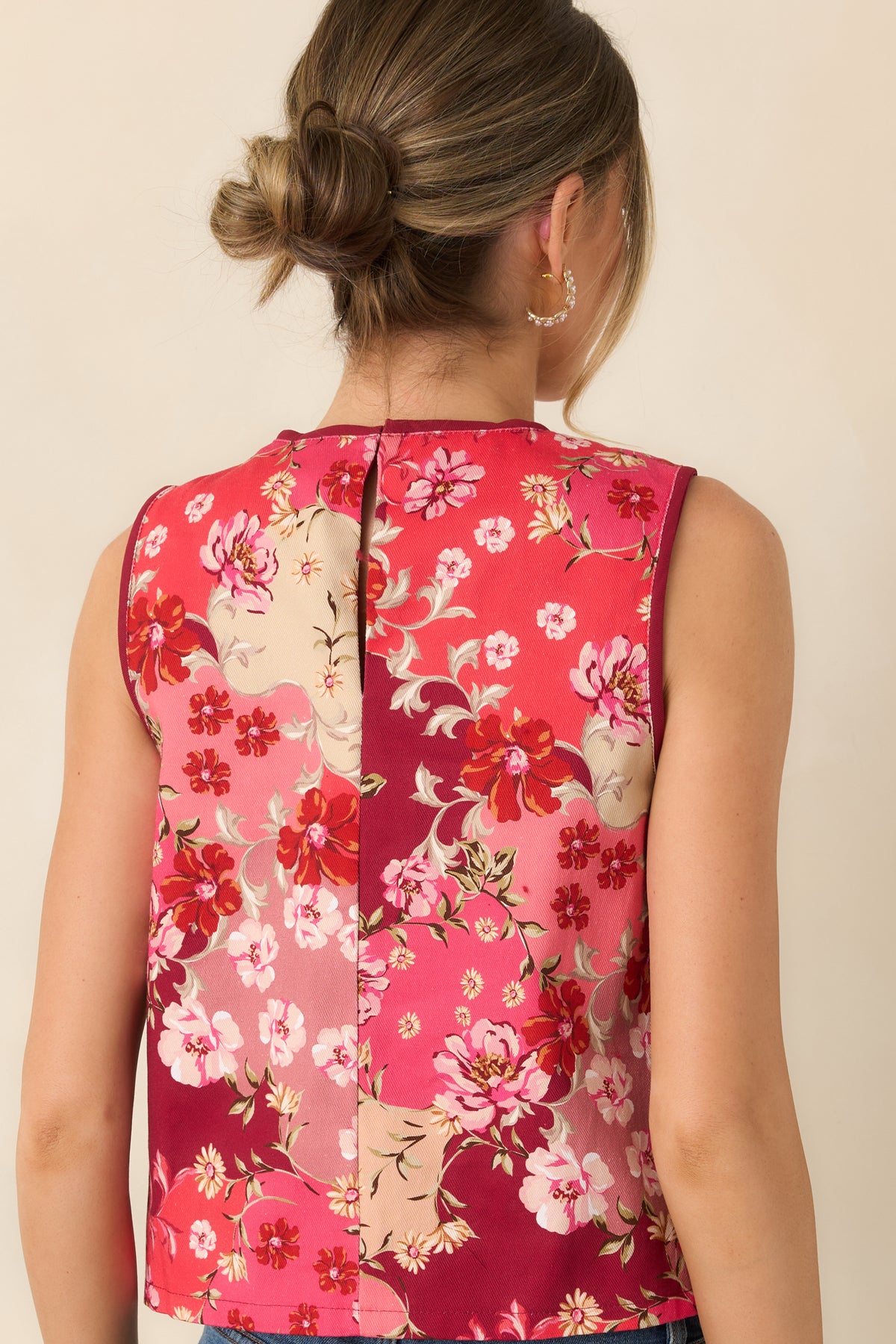Rear of the floral cotton top featuring a back keyhole detail, burgundy neckline trim, and multicolor botanical print.