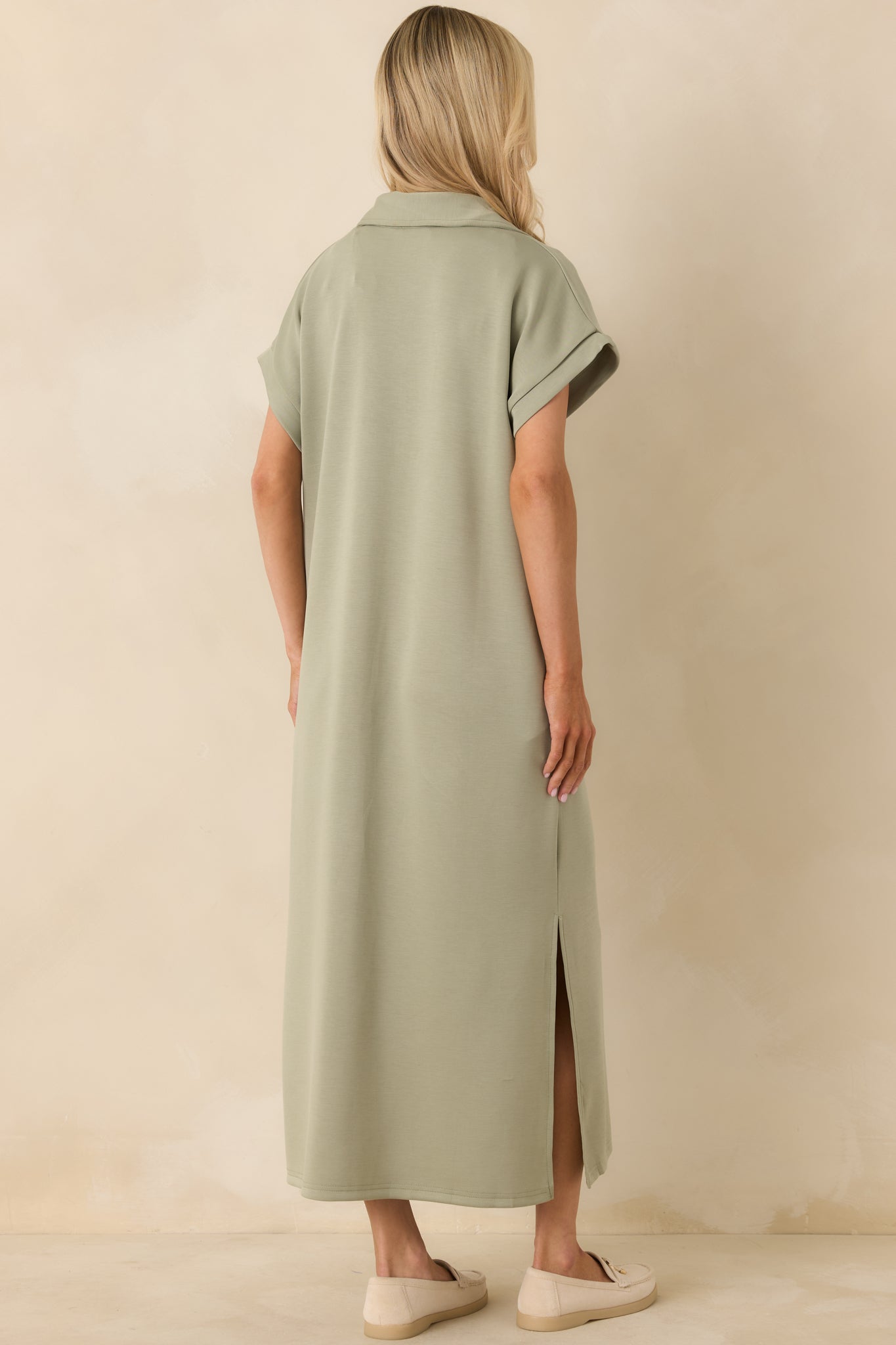 Rear of the sage green midi dress highlighting the clean back panel, relaxed fit, and continuous soft fabric finish.
