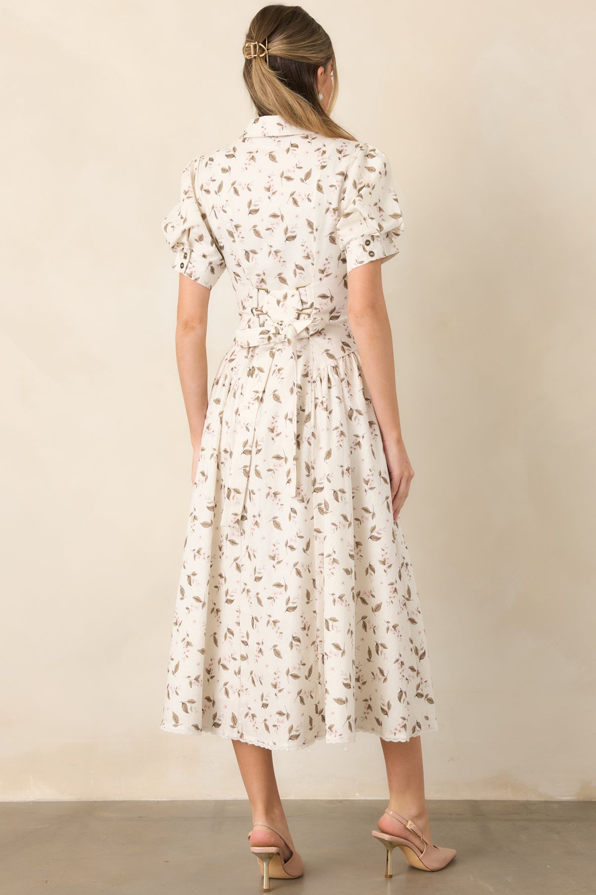 Rear of the ivory floral midi dress features a lace-up back and gathered skirt extending to the lace-trimmed hem.