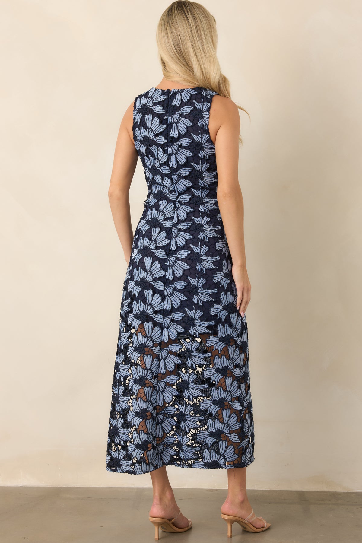 Rear of the light blue floral dress showcasing the sleeveless silhouette, gently flared skirt, and concealed zipper.
