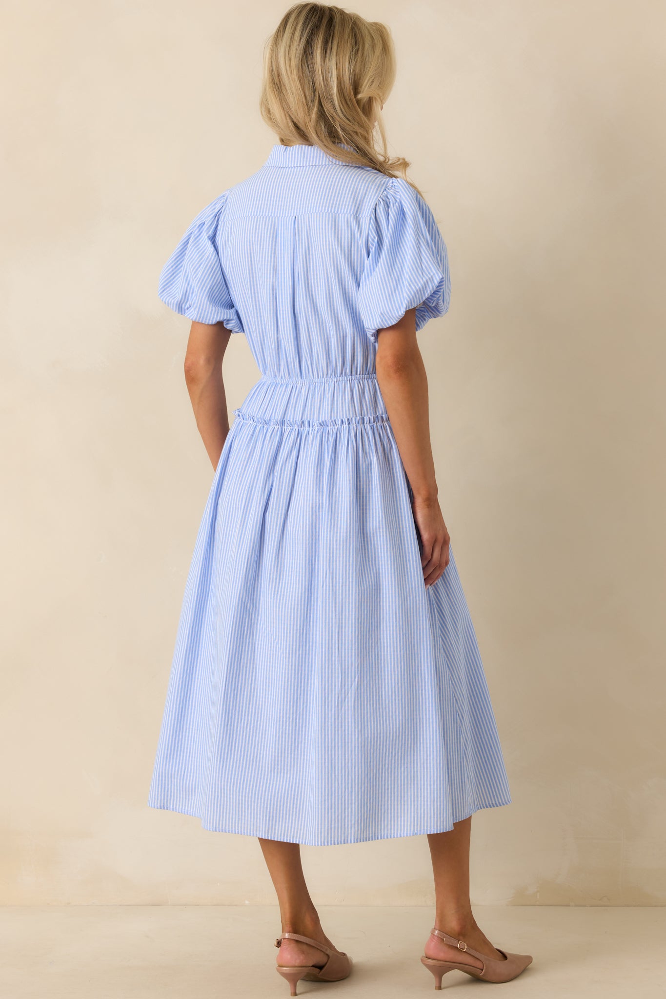 Rear view of the maxi dress, featuring the elastic waist insert, stripe pattern, and puff sleeve details.