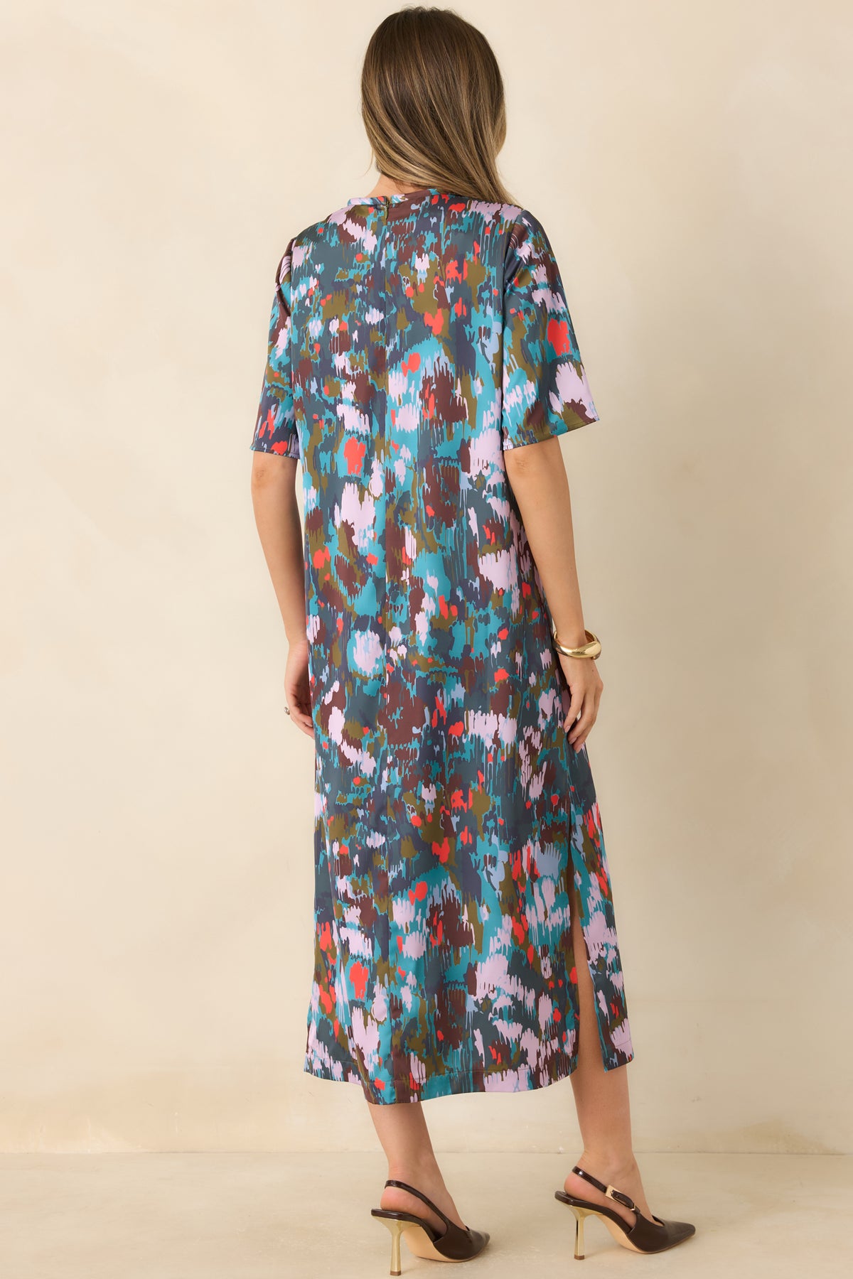 Rear view of the midi dress featuring a concealed back zipper, relaxed short sleeves, and a flowing skirt.