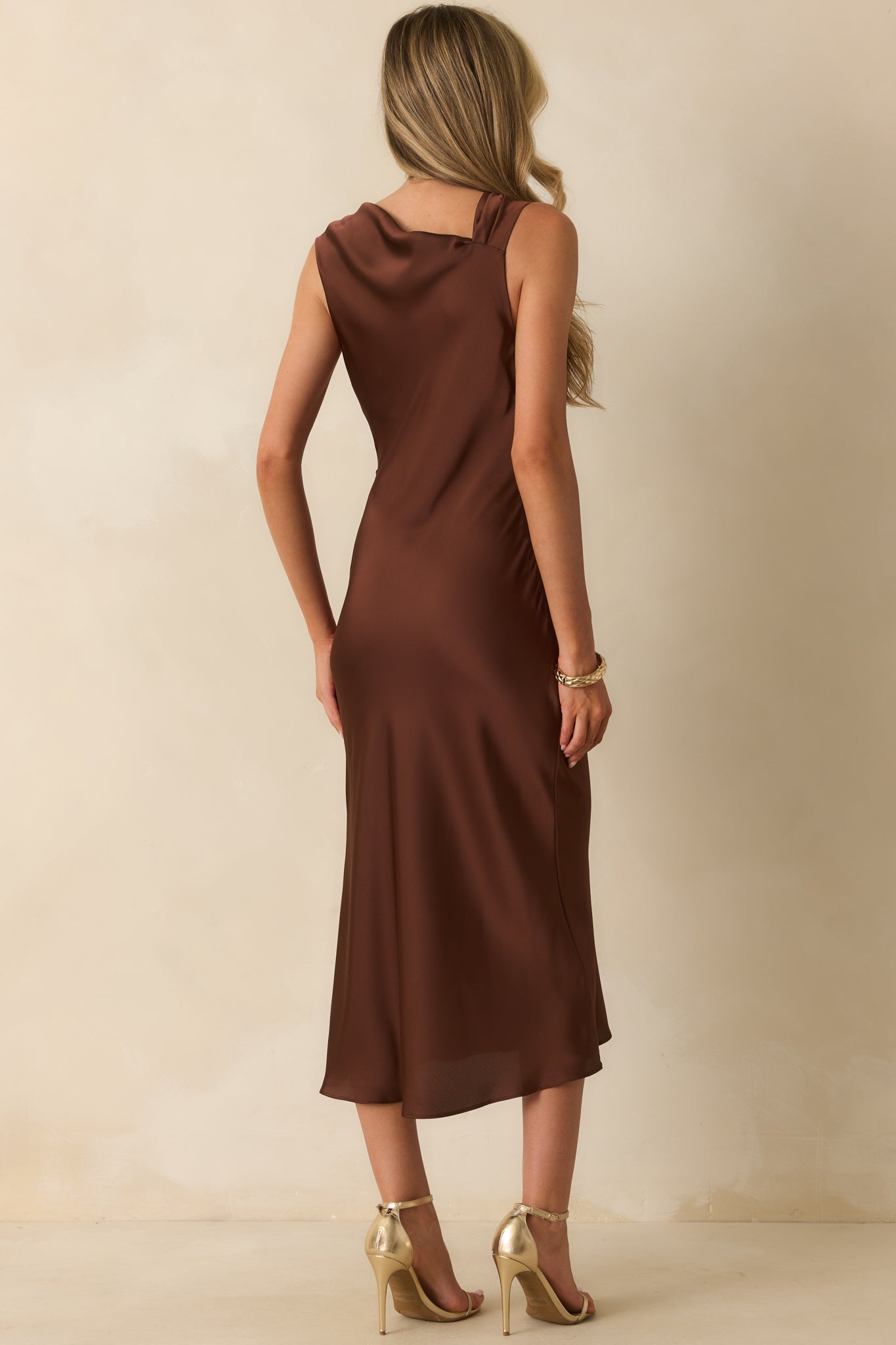 Rear view of the midi dress showing the smooth satin fabric and concealed side zipper.
