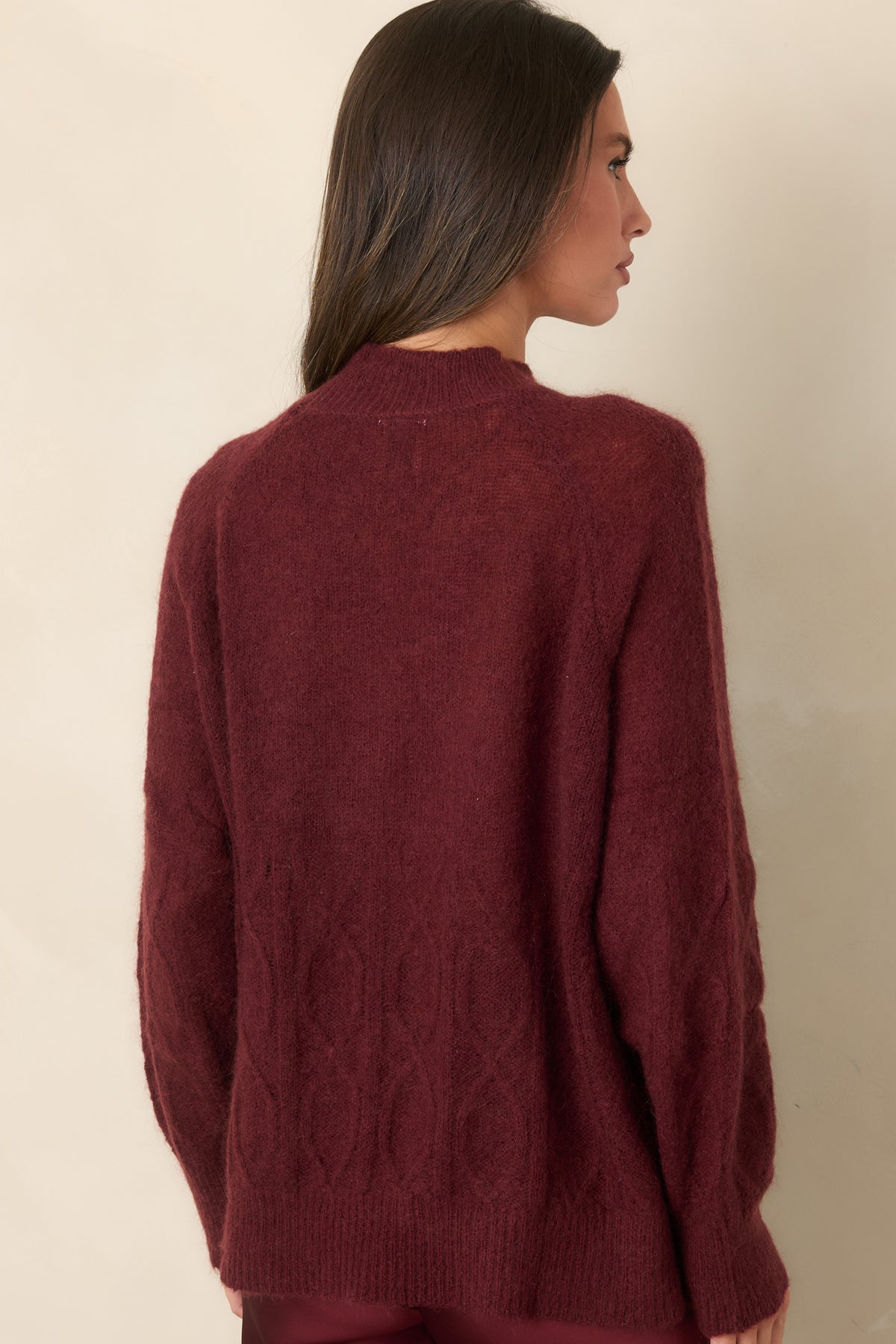 Rear of the fuzzy mohair-wool knit top showcasing the relaxed raglan sleeves and cable detailing across the lower back.