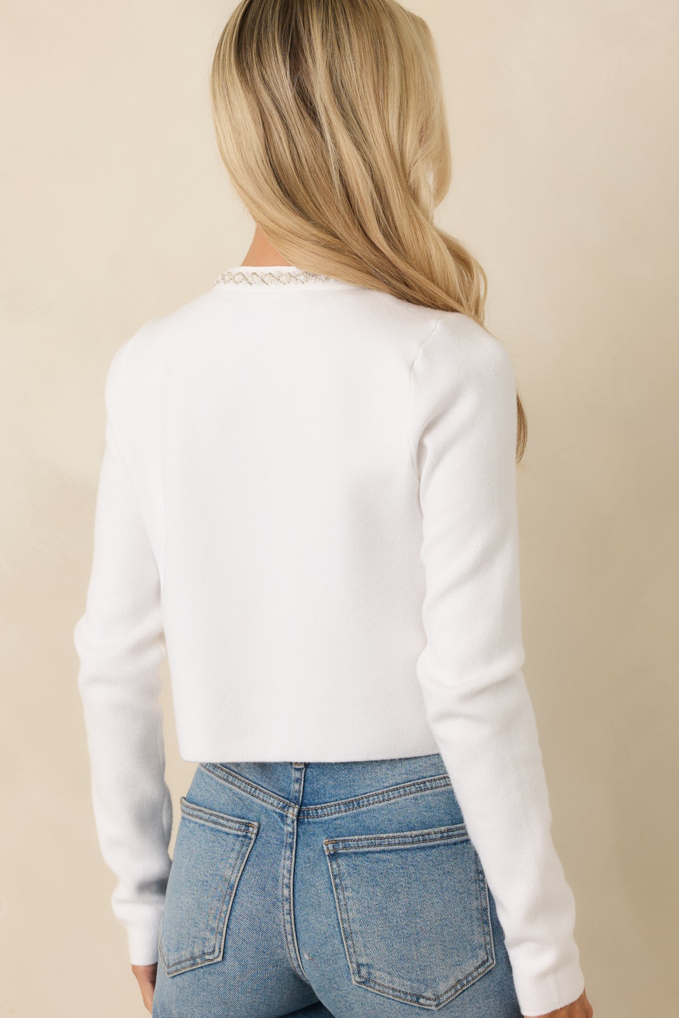 Rear photo of the ivory cardigan featuring a clean hemline, structured stretch-knit fabric, and a comfortable tailored fit.