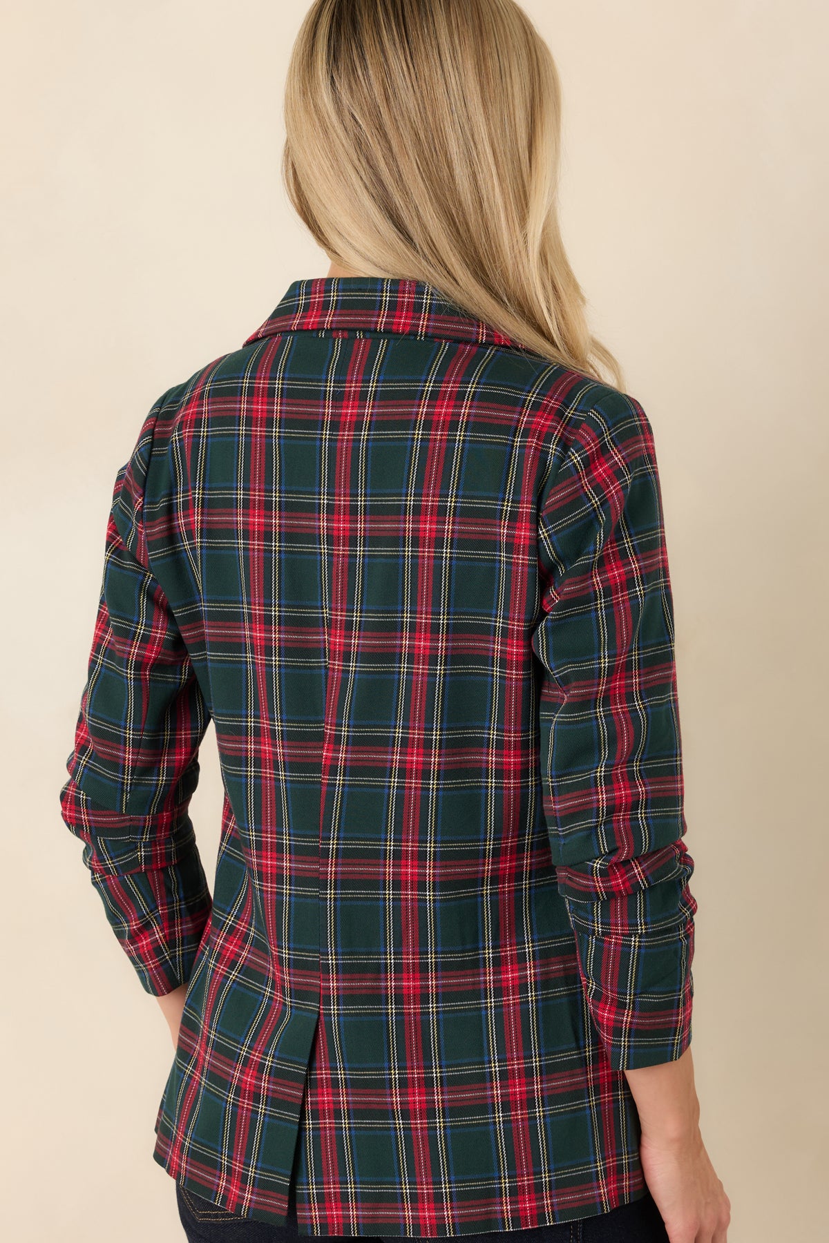Rear view of the red tartan blazer featuring a center back vent and a tailored plaid silhouette.