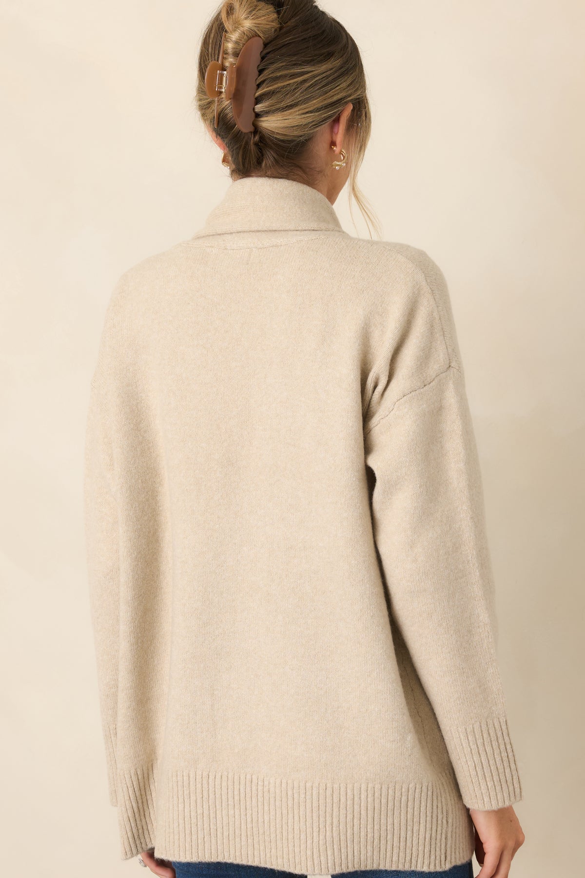 Rear of the relaxed cardigan showing its dropped shoulders, long sleeves, and ribbed hem.