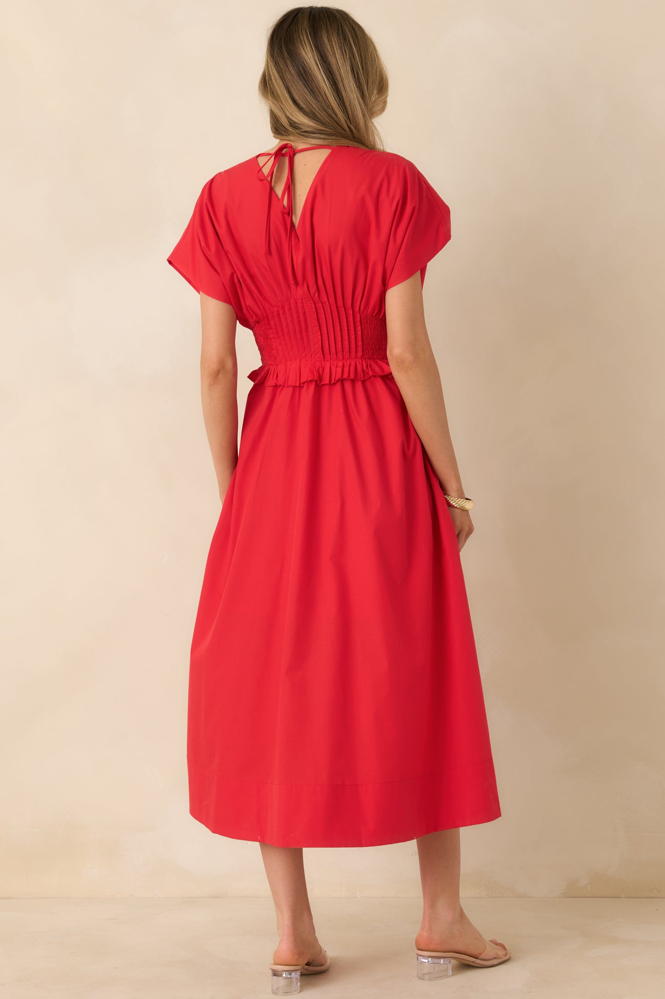 Rear of the cherry red maxi dress showing a smooth uninterrupted back panel and the stretch smocked waistband carried through the design.