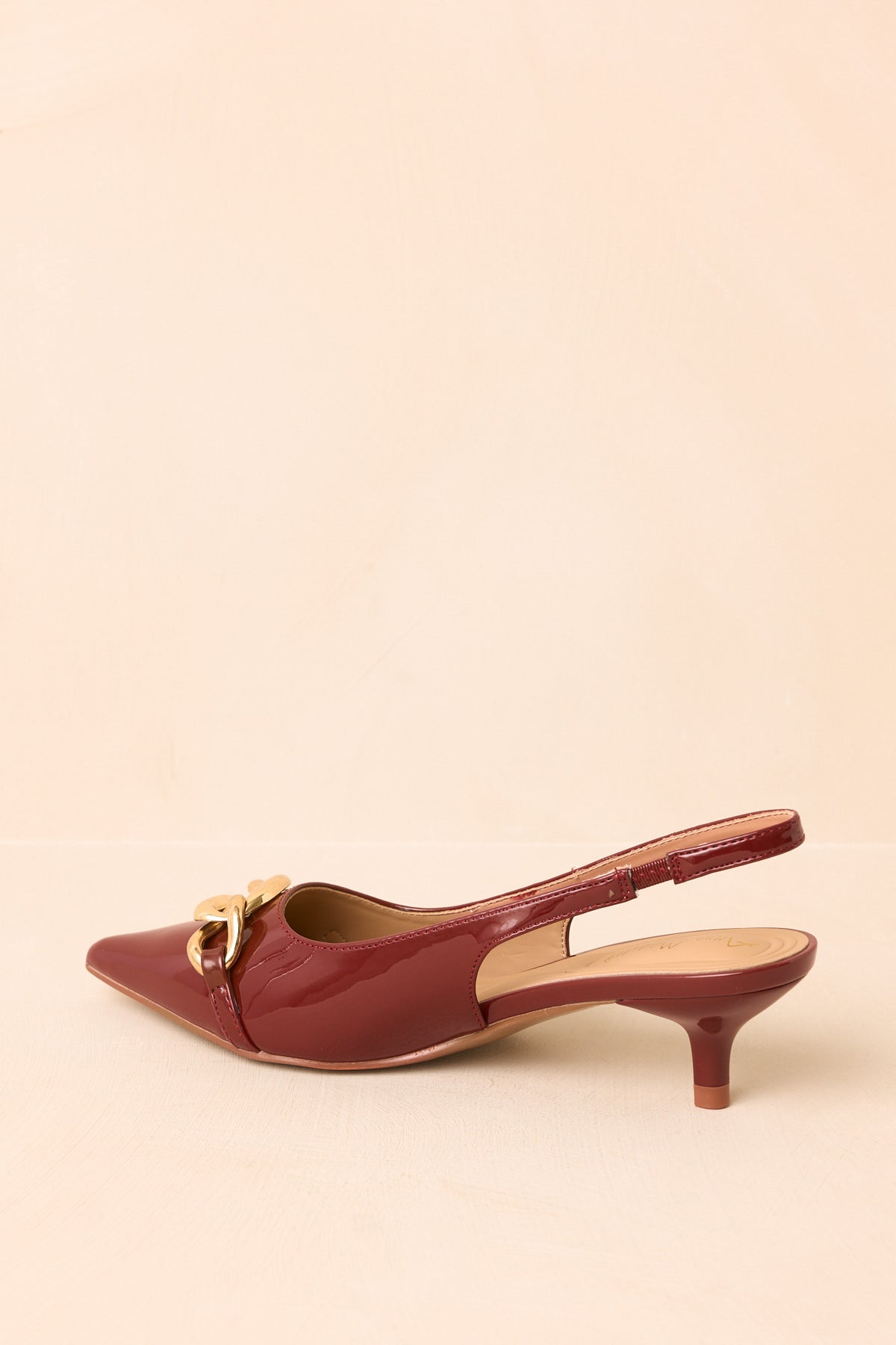 Rear of the sienna slingback heels showing the open design and low kitten heels.