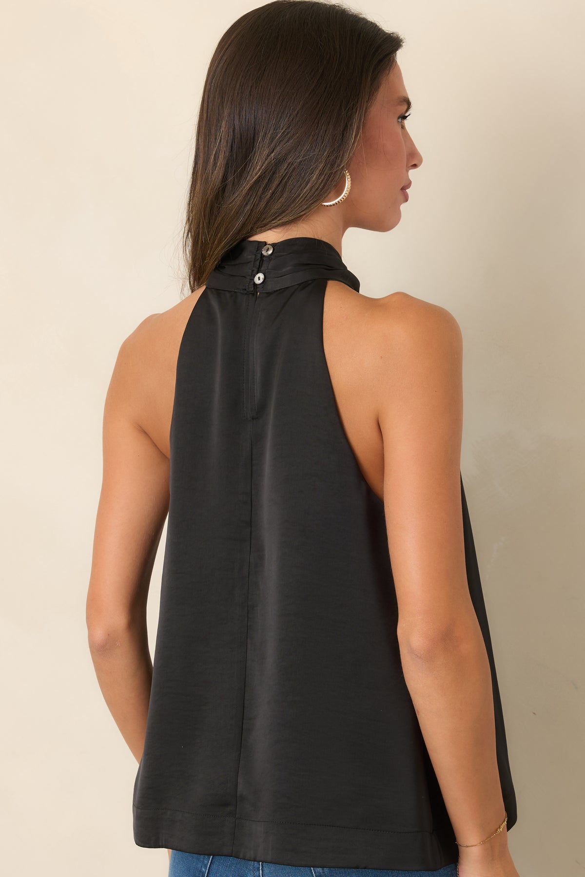 Rear of the sleeveless top maintains a simple, polished silhouette without the front neckline ring detail.