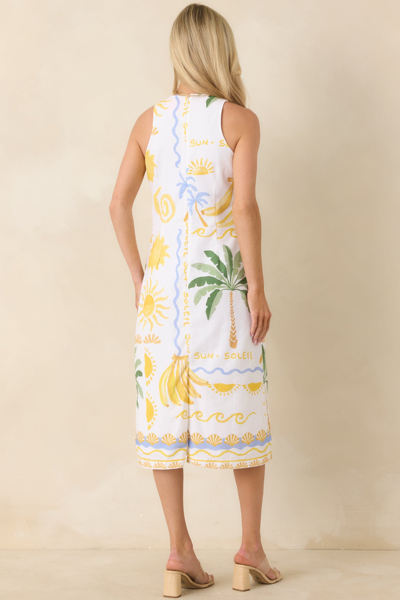 Rear view of the tank top showing the relaxed, slightly cropped fit, wide shoulder straps, and continuation of the tropical print across the back.