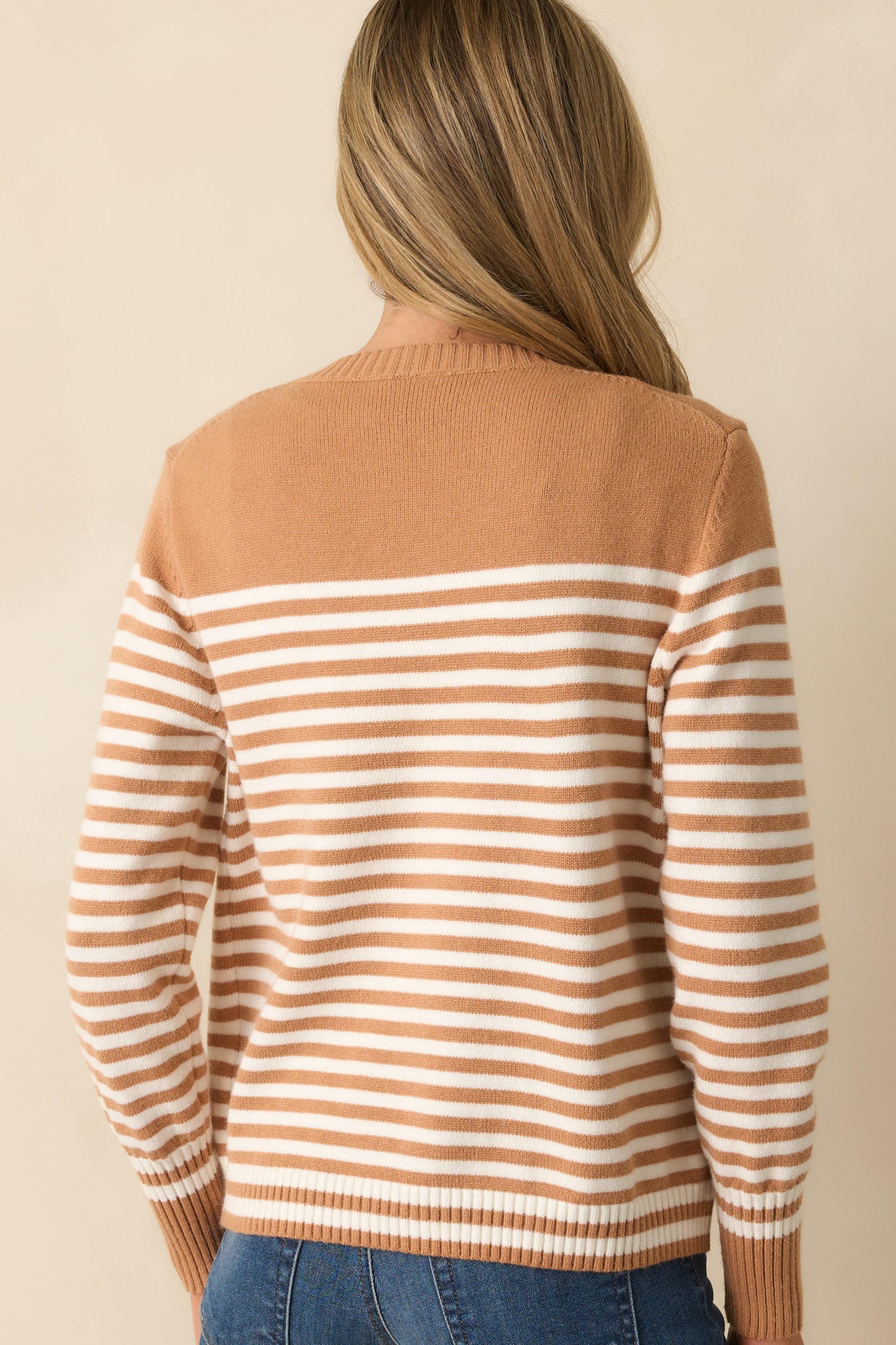 Rear view of the camel brown cardigan showing long sleeves, ribbed hem, and relaxed silhouette.