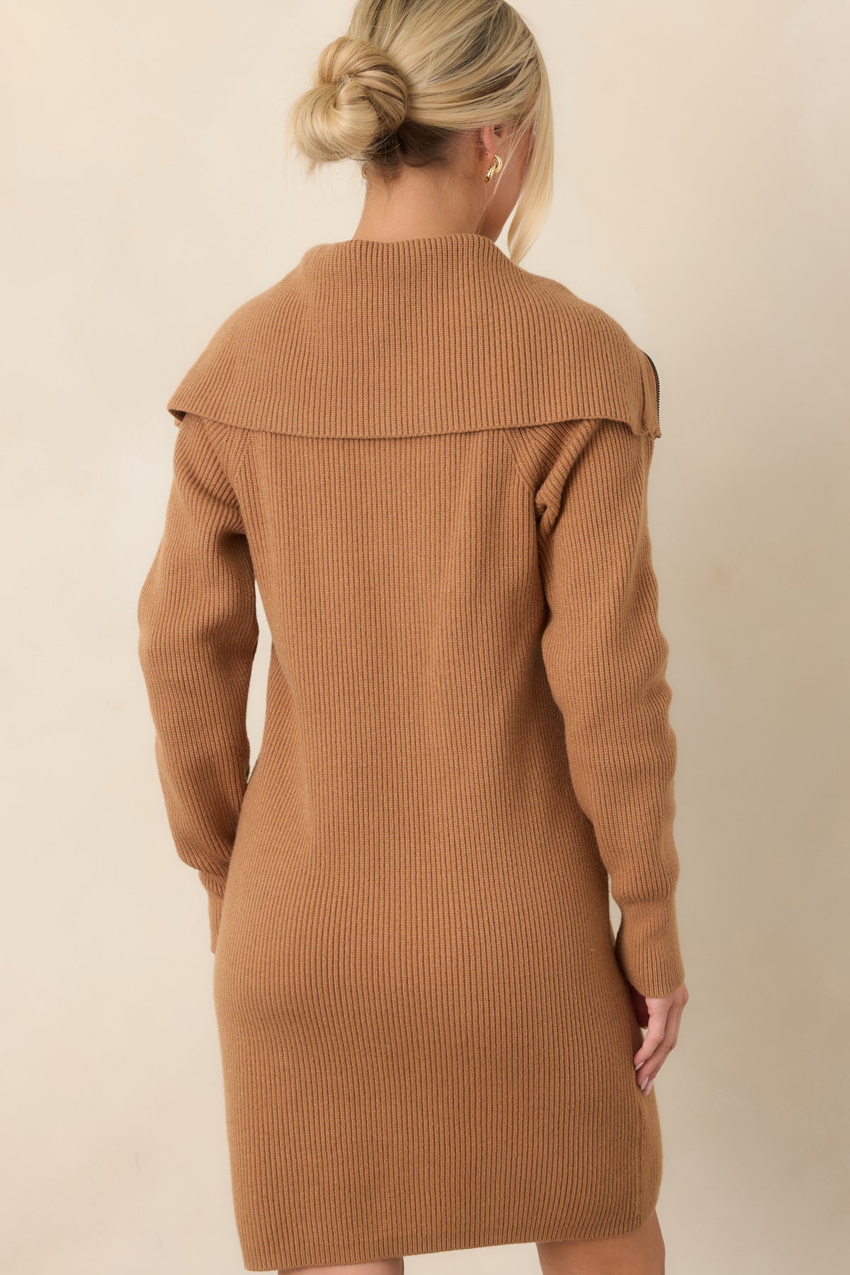 Rear view of the camel brown ribbed knit dress showcasing its relaxed longline silhouette, long sleeves, and straight hem.