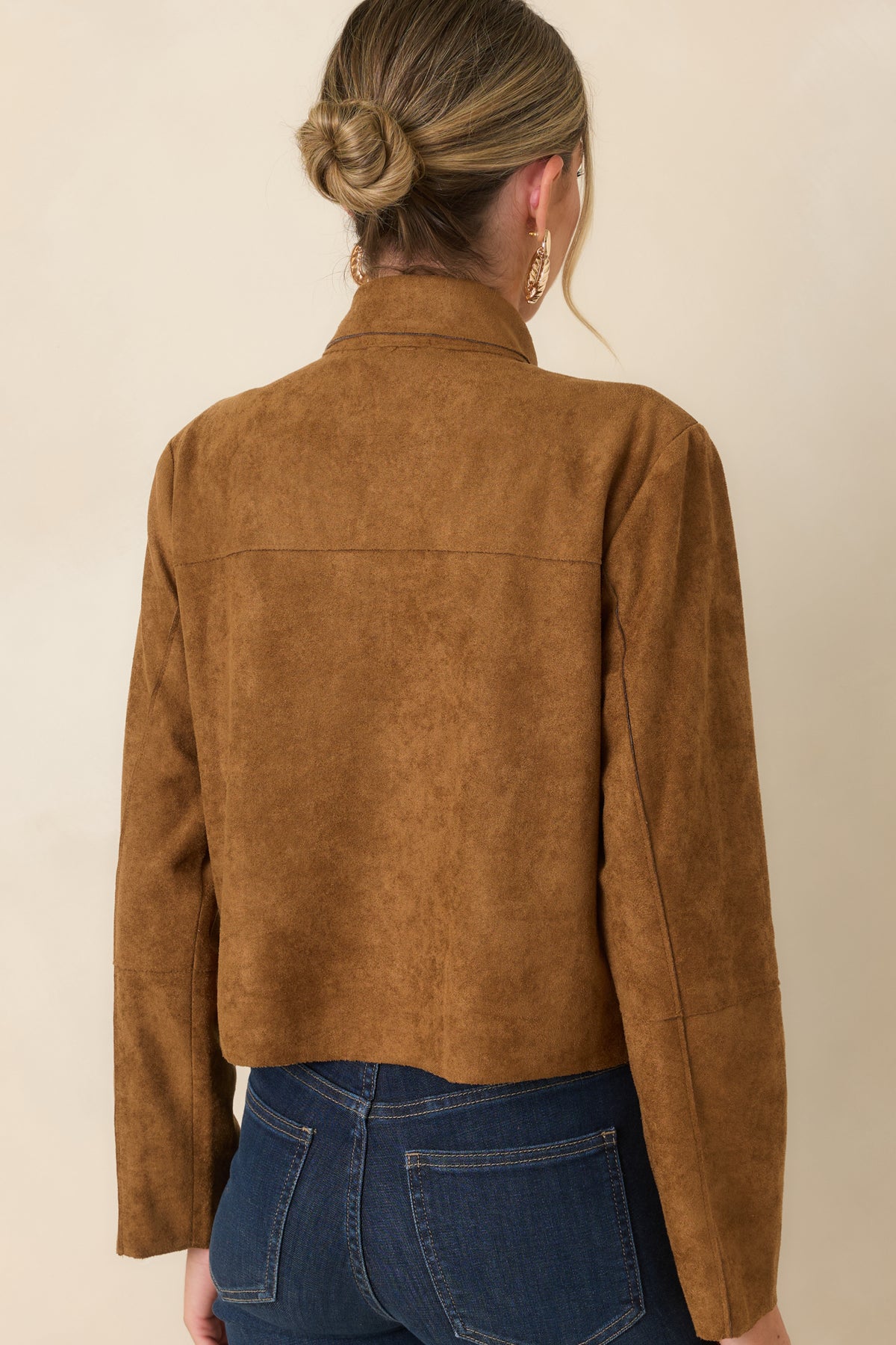 Rear view of the camel faux suede jacket showcasing the cropped silhouette, long sleeves, lightly structured shape, and smooth back finish.