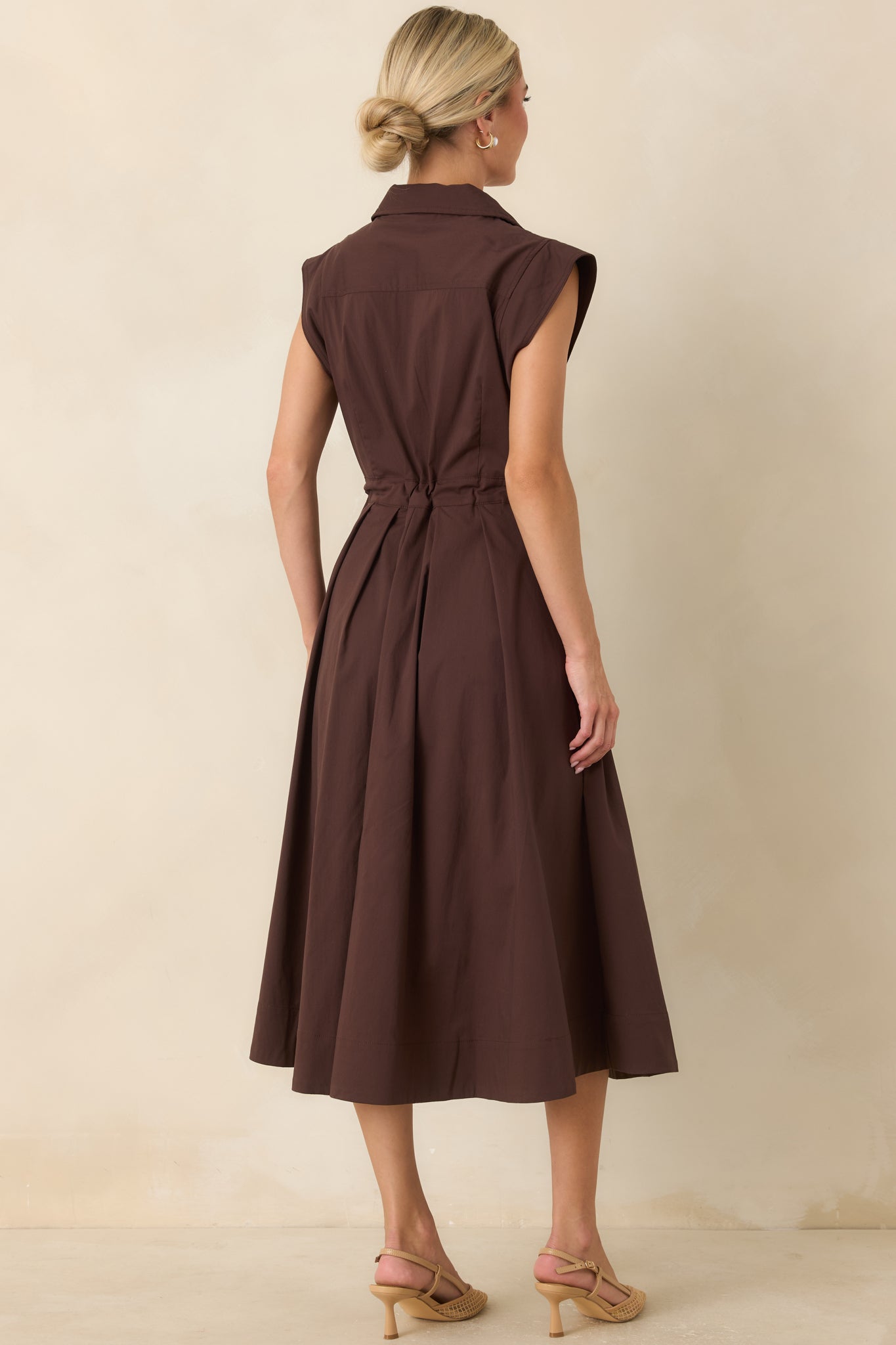 Rear view of the cotton poplin midi dress featuring cap sleeves and a full flowing skirt.