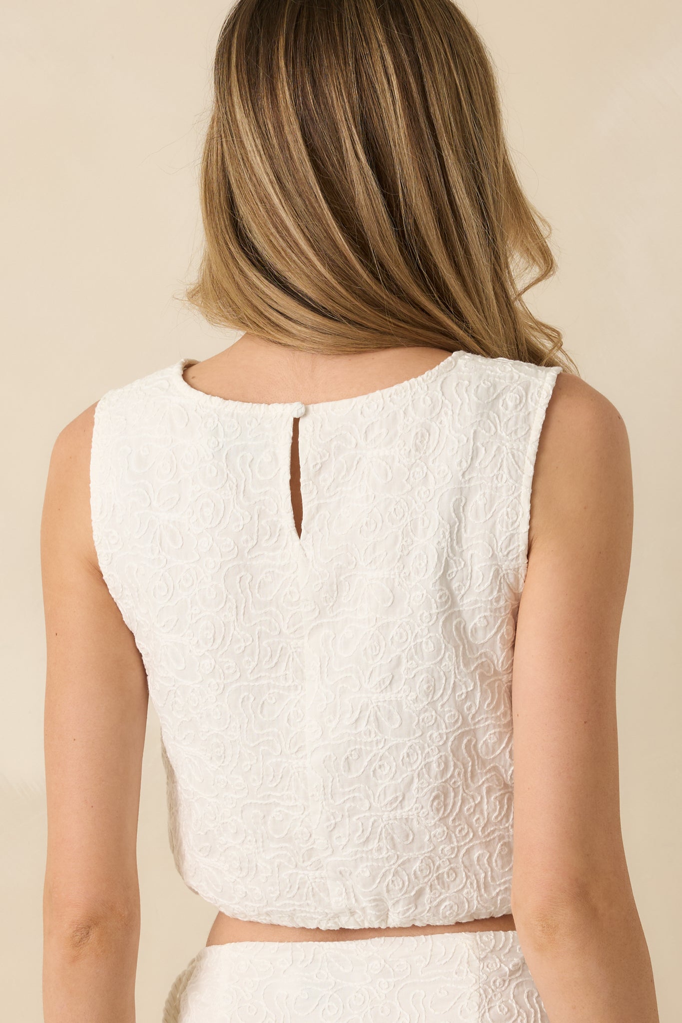Rear view of the cropped tank top showing smooth cotton jacquard fabric and clean finish.