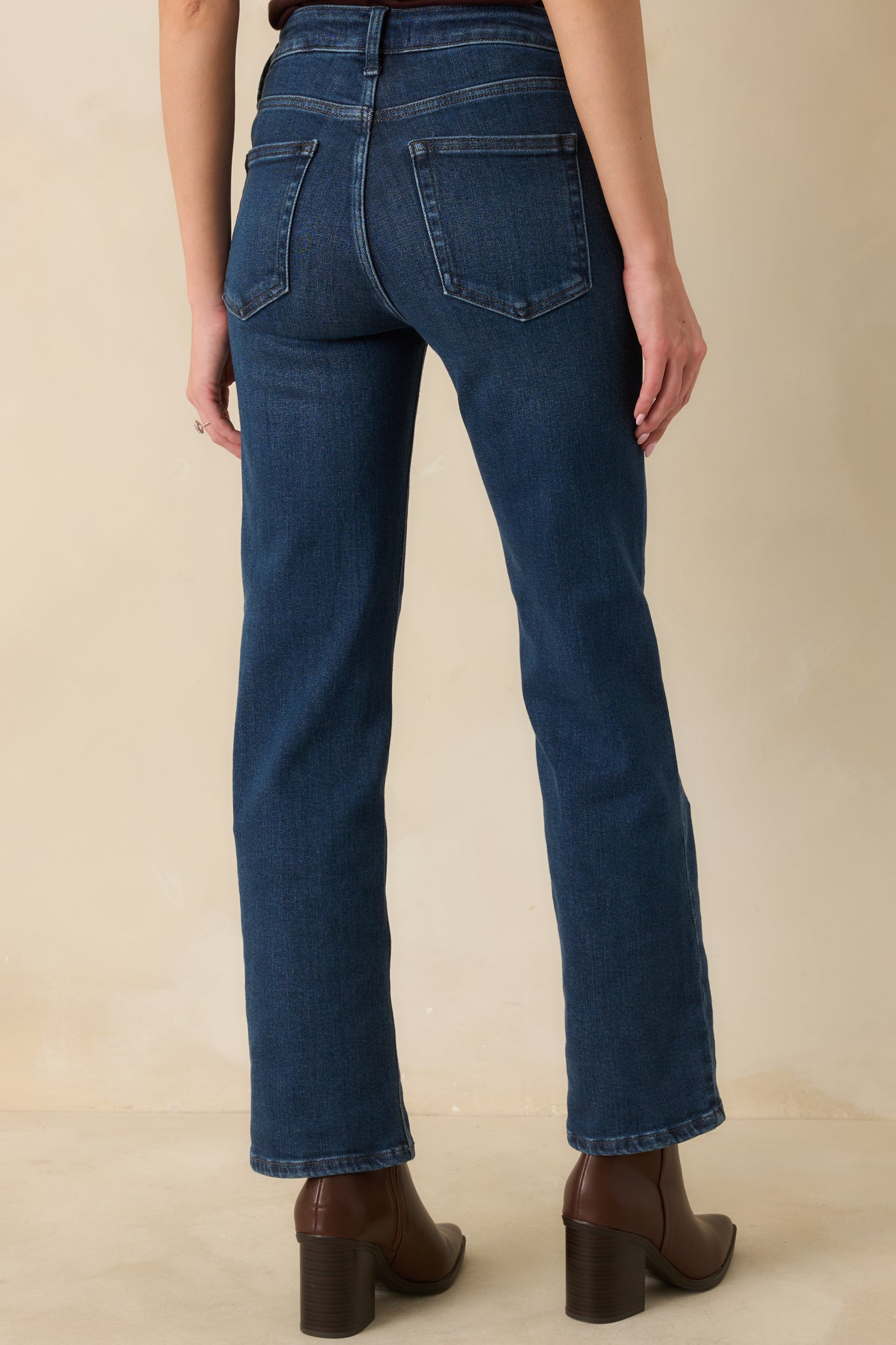 Rear view of the dark wash jeans showing clean pocket placement and straight leg lines.