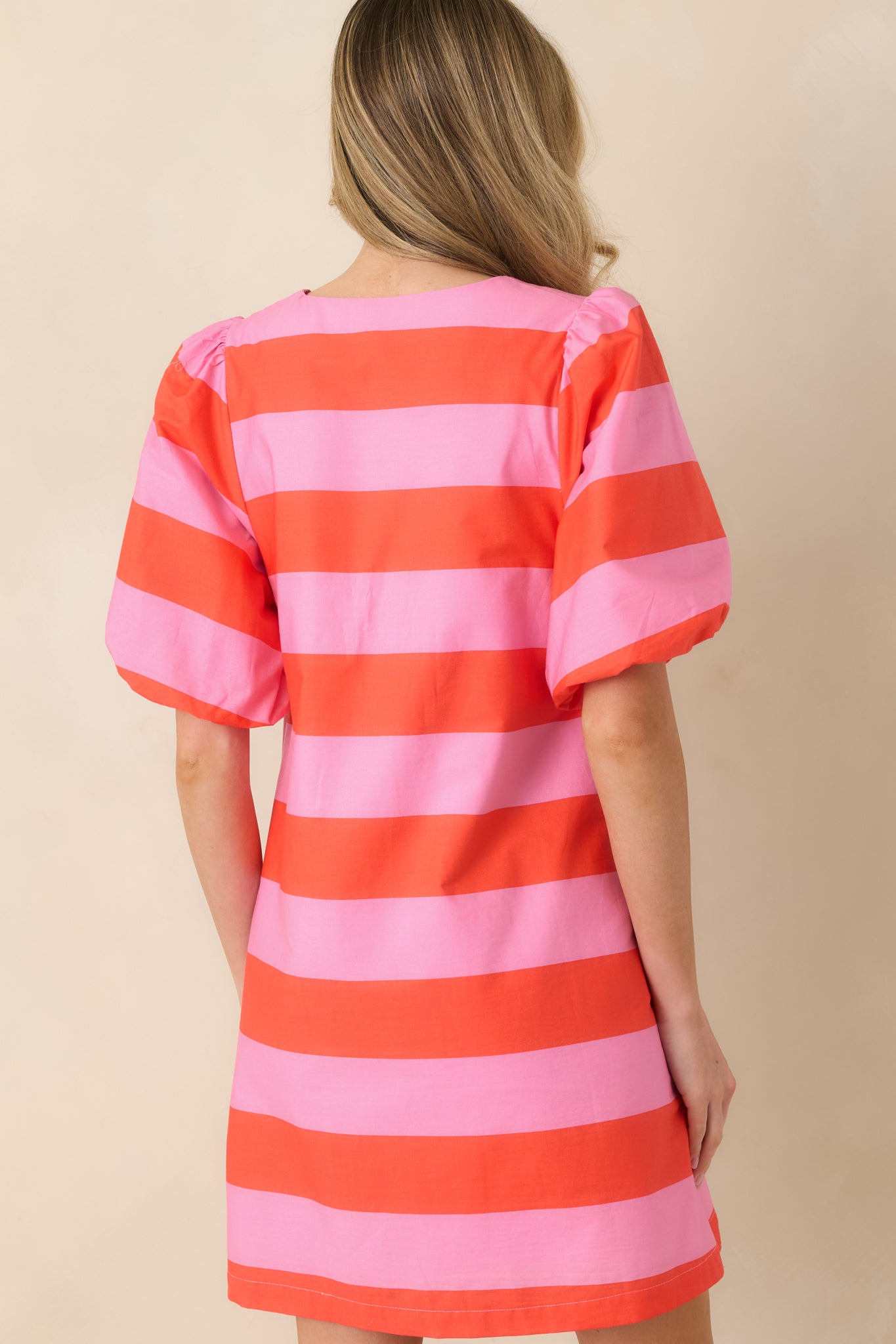 Rear view of the striped mini dress featuring the continuous bold stripe pattern and flattering shape