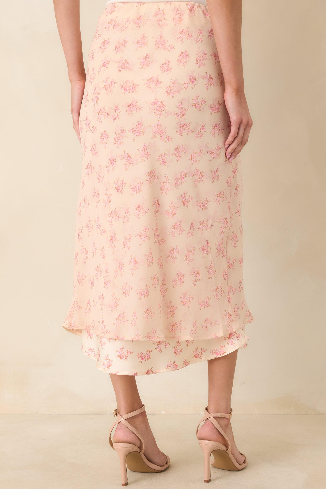 Rear view of the pink floral midi skirt featuring the same flowing chiffon layers and easy pull-on silhouette.