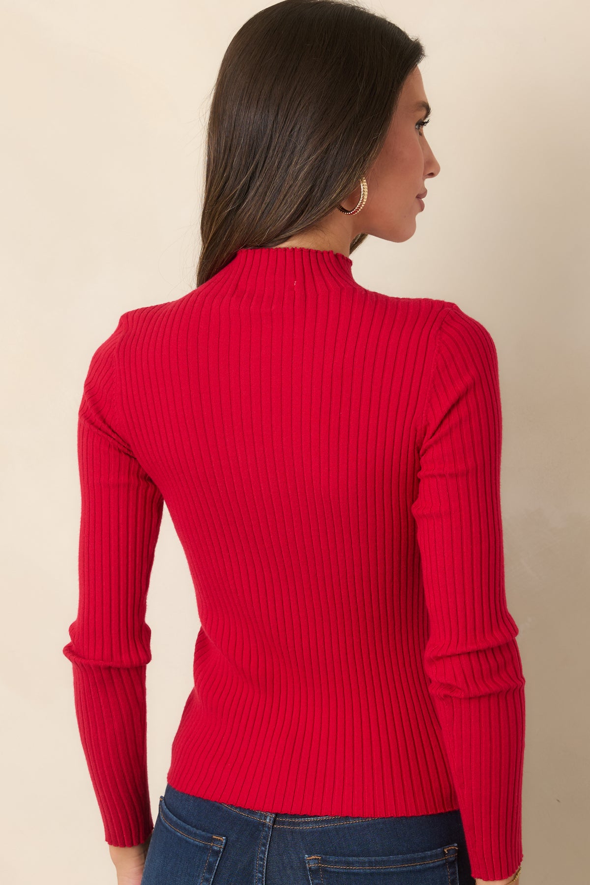 Rear view of the fitted ribbed knit top with matching ruffle sleeve accents.