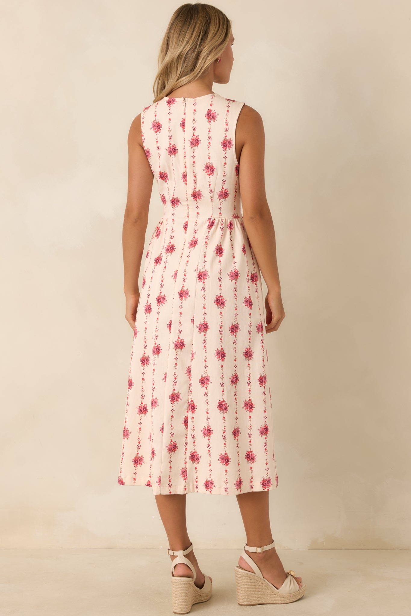 Rear view of the sleeveless floral stripe midi dress featuring a concealed back zipper, fitted waist, and flared silhouette.