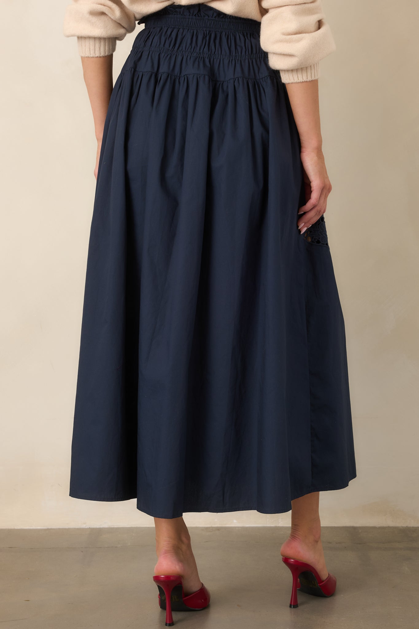 Rear view of the flowing cotton skirt highlighting its full silhouette, lightweight unlined construction, and elastic gathered waistband.