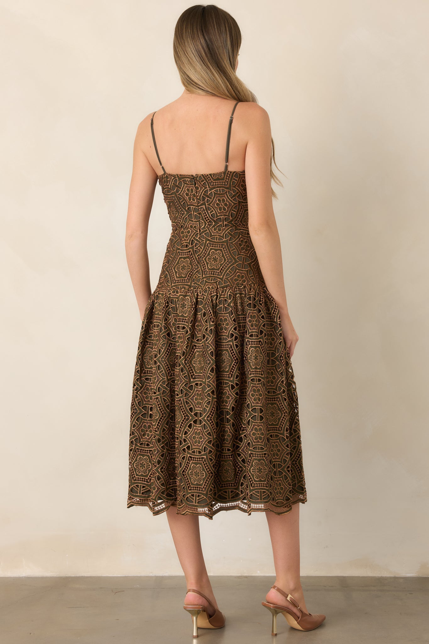 Rear view of the gold lace midi dress showing the fitted bodice, adjustable straps, gathered skirt, and back zipper closure.