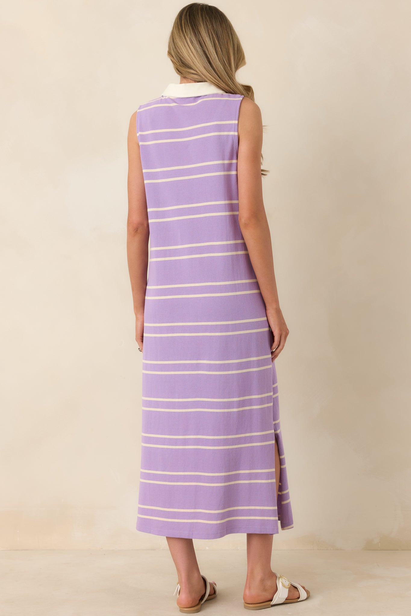 Rear view of the lavender and neutral striped dress highlighting the straight silhouette and continuous stripe design.